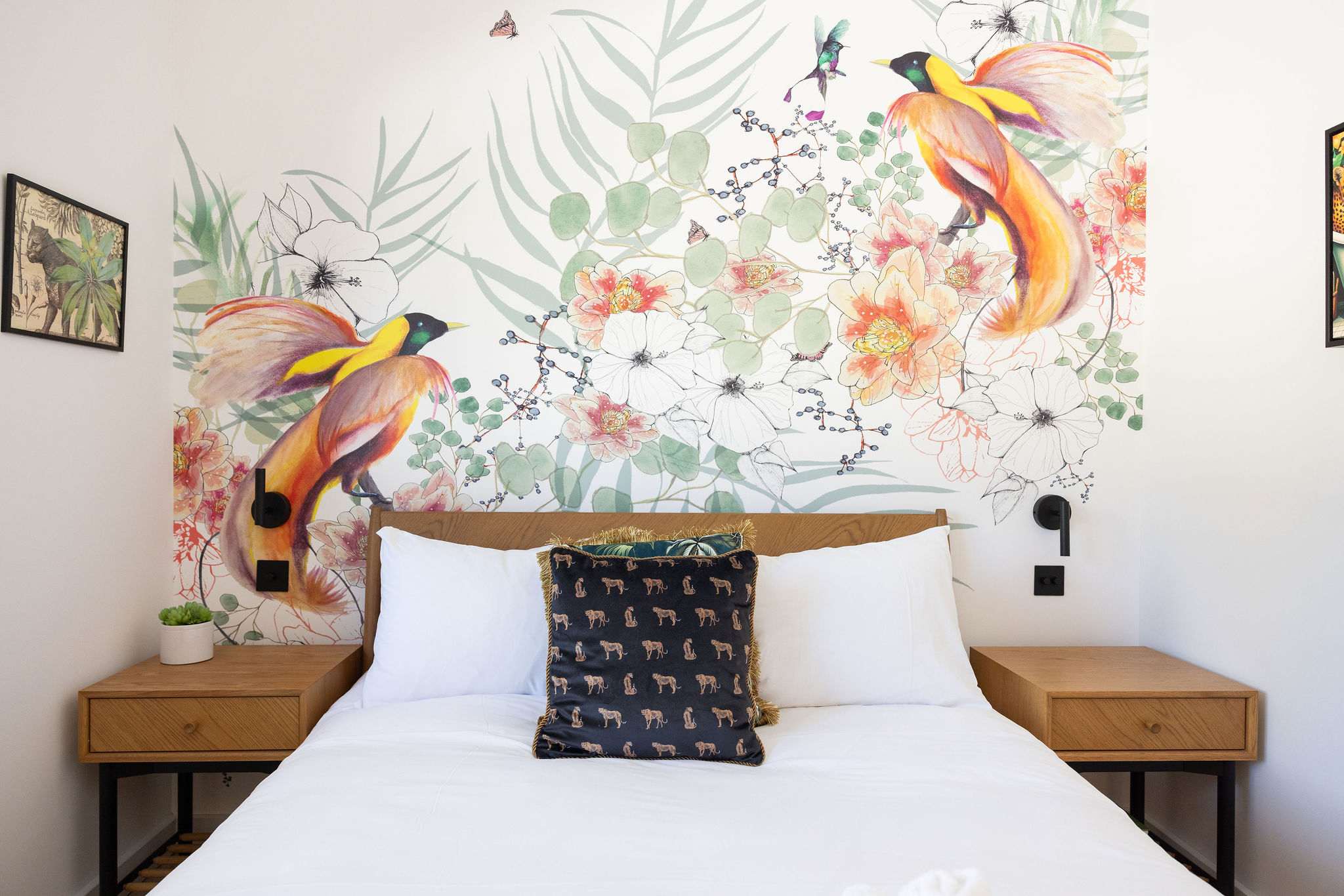 Settle into a peaceful king bedroom with playful botanical wallpaper, cosy touches, and easy Sussex comfort.