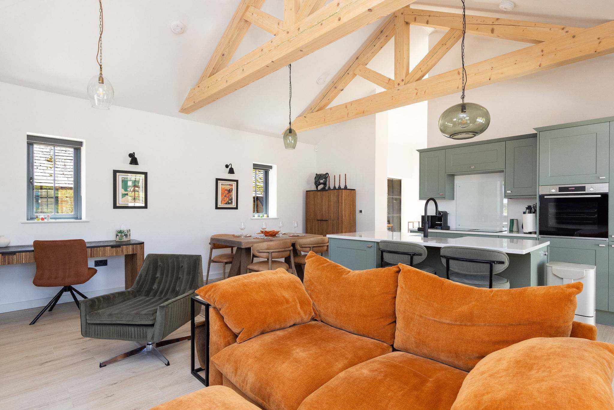 Relax in bright open-plan comfort, with cosy seating, vaulted beams, and space to unwind after Sussex adventures.
