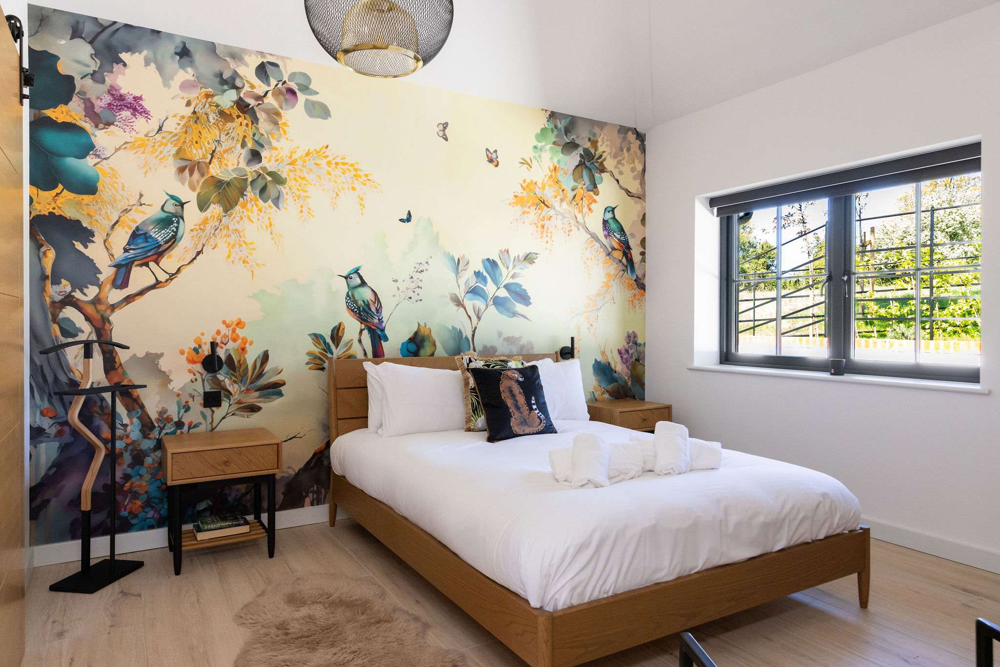 Sleep easy in a stylish king bedroom, surrounded by calming colours and a soft countryside feel.