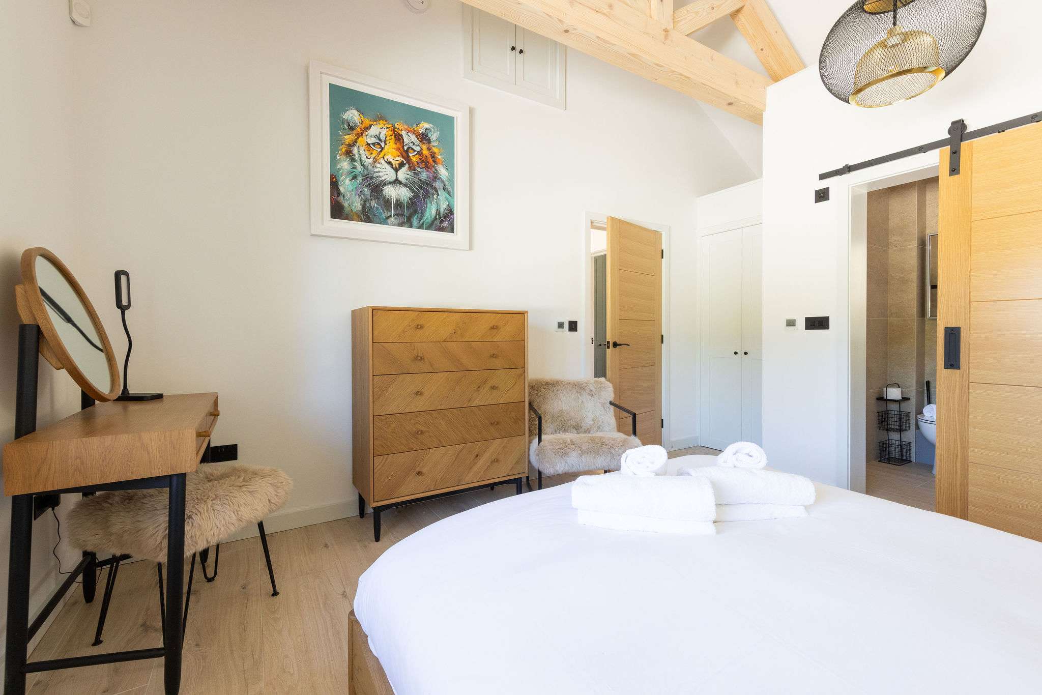 Wake up slowly in a calm bedroom with rustic touches, soft light, and relaxed lodge comfort.