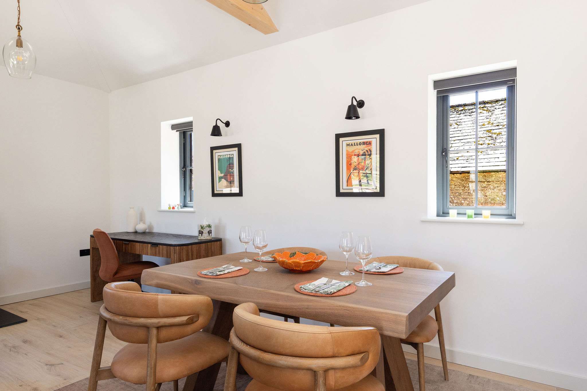 Enjoy slow dinners in a bright dining space with soft light, simple style, and countryside calm.