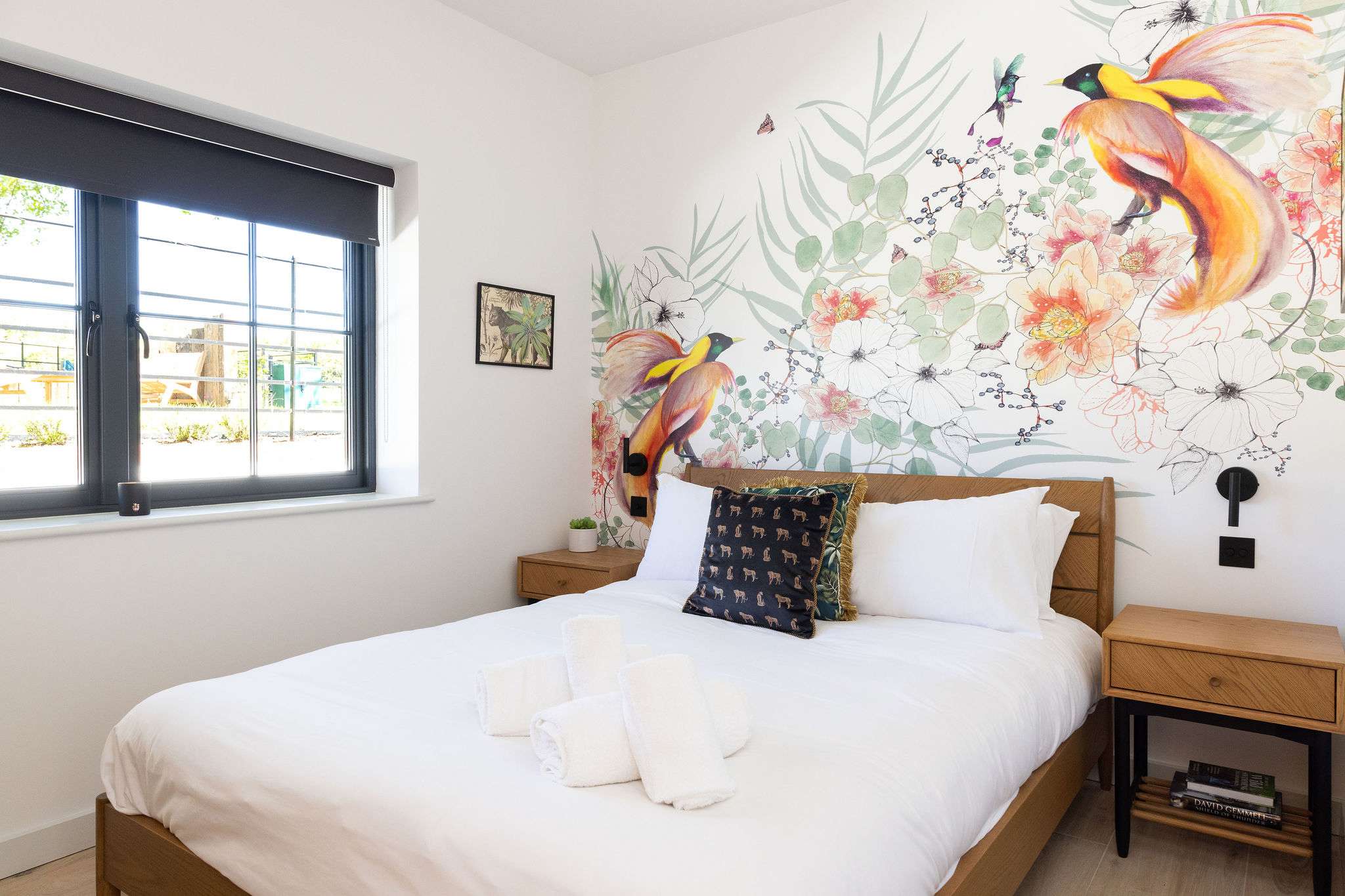 Wake gently in a bright bedroom with soft linens, garden views, and calming nature-inspired decor.