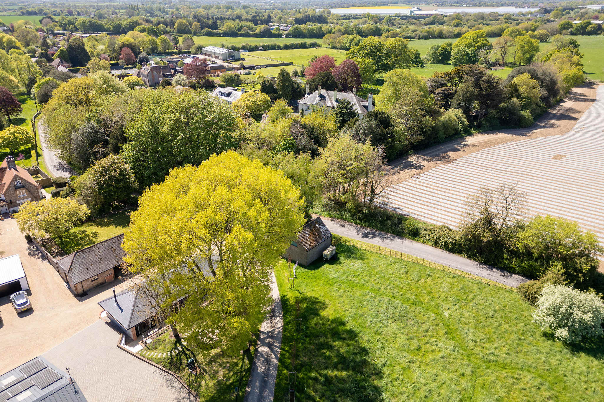 Take in sweeping green views, open fields, and peaceful seclusion across the wider Sussex landscape.
