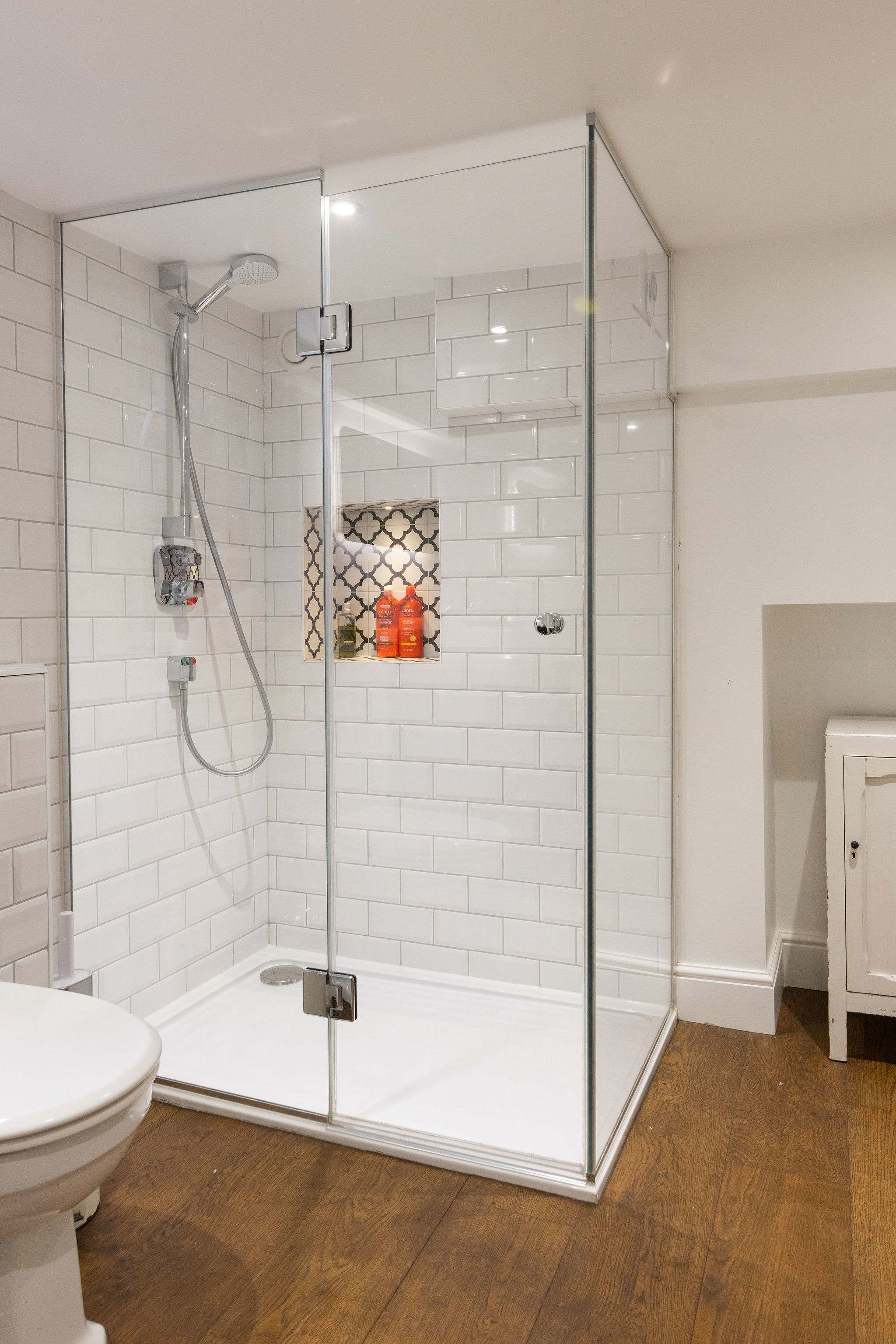Spacious rainfall shower with elegant tiled finish