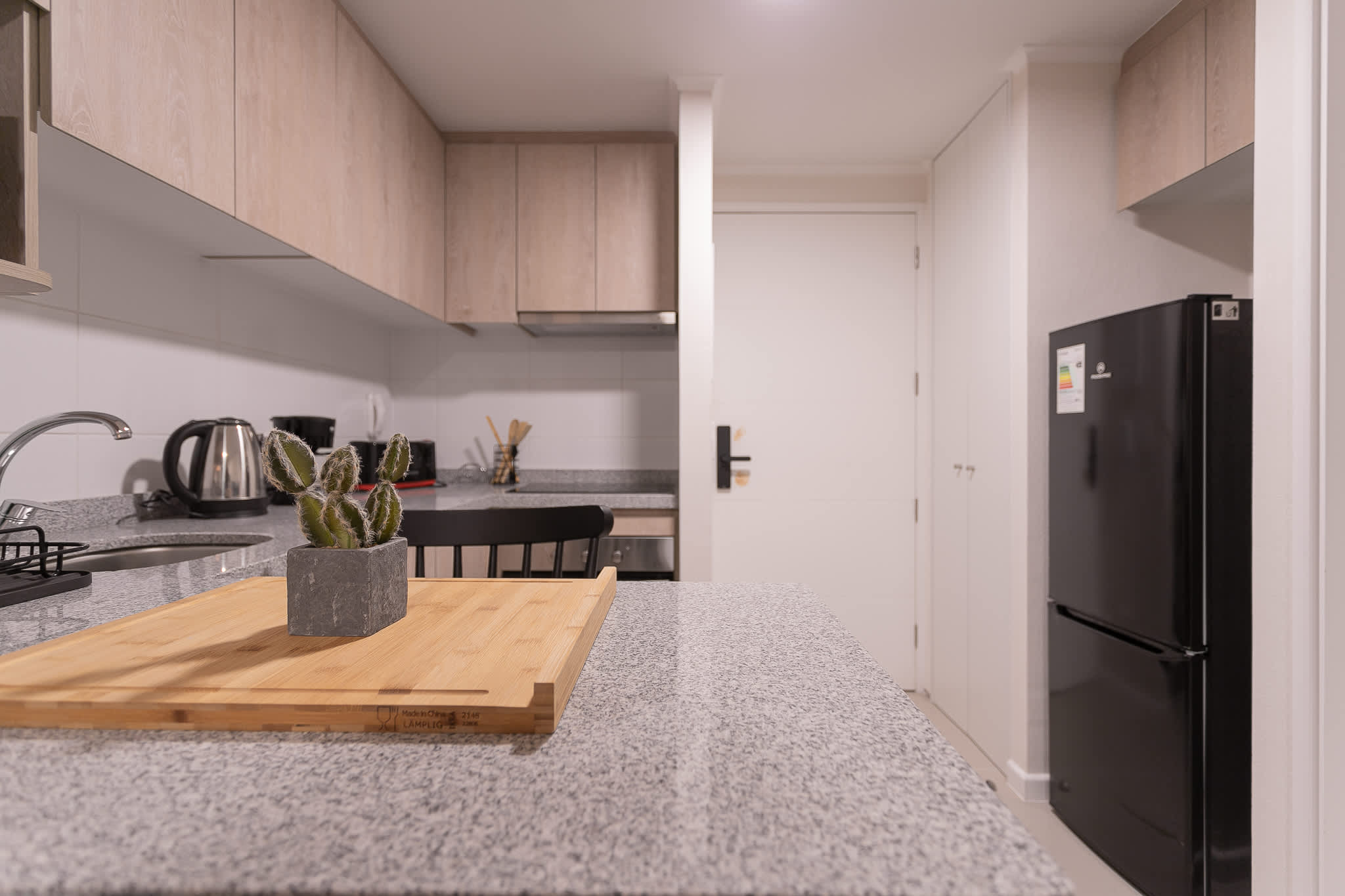 Sleek and modern kitchen with granite countertops and stylish cabinetry, perfect for preparing meals during your stay.