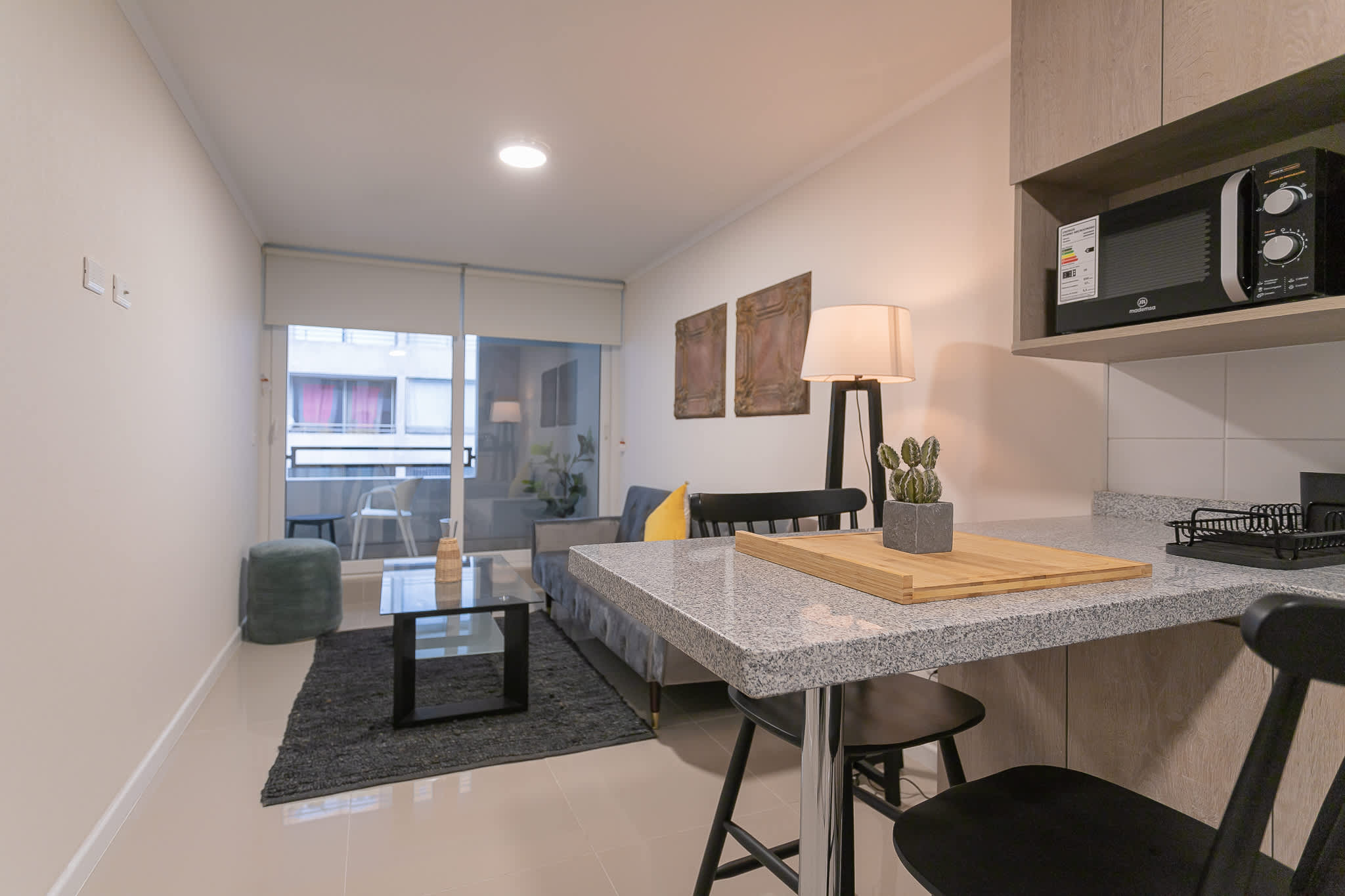 Cozy studio living area with modern decor and natural light, perfect for relaxing after exploring the city.