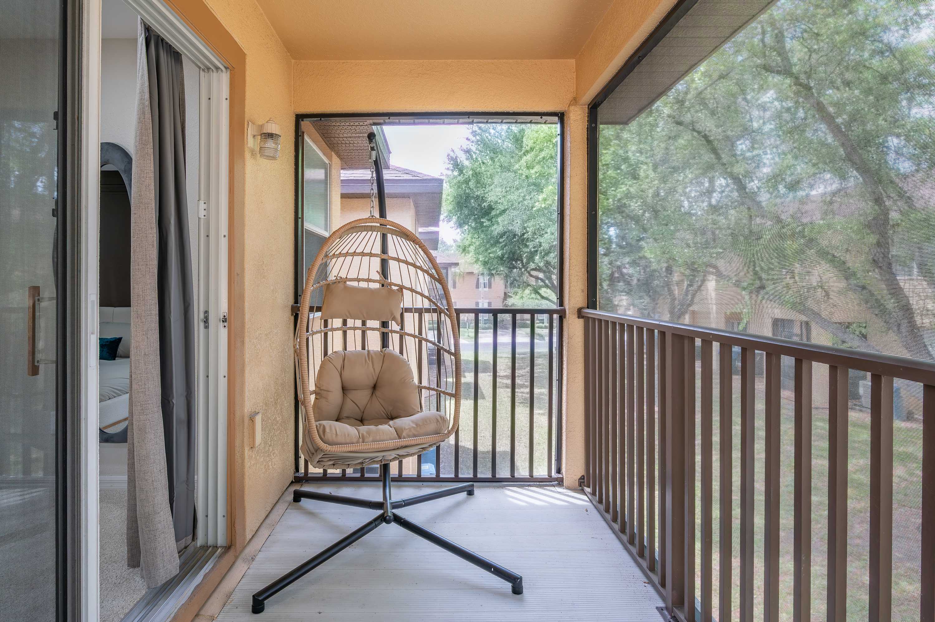 Covered walkway w/ outdoor seating & views of surrounding greenery