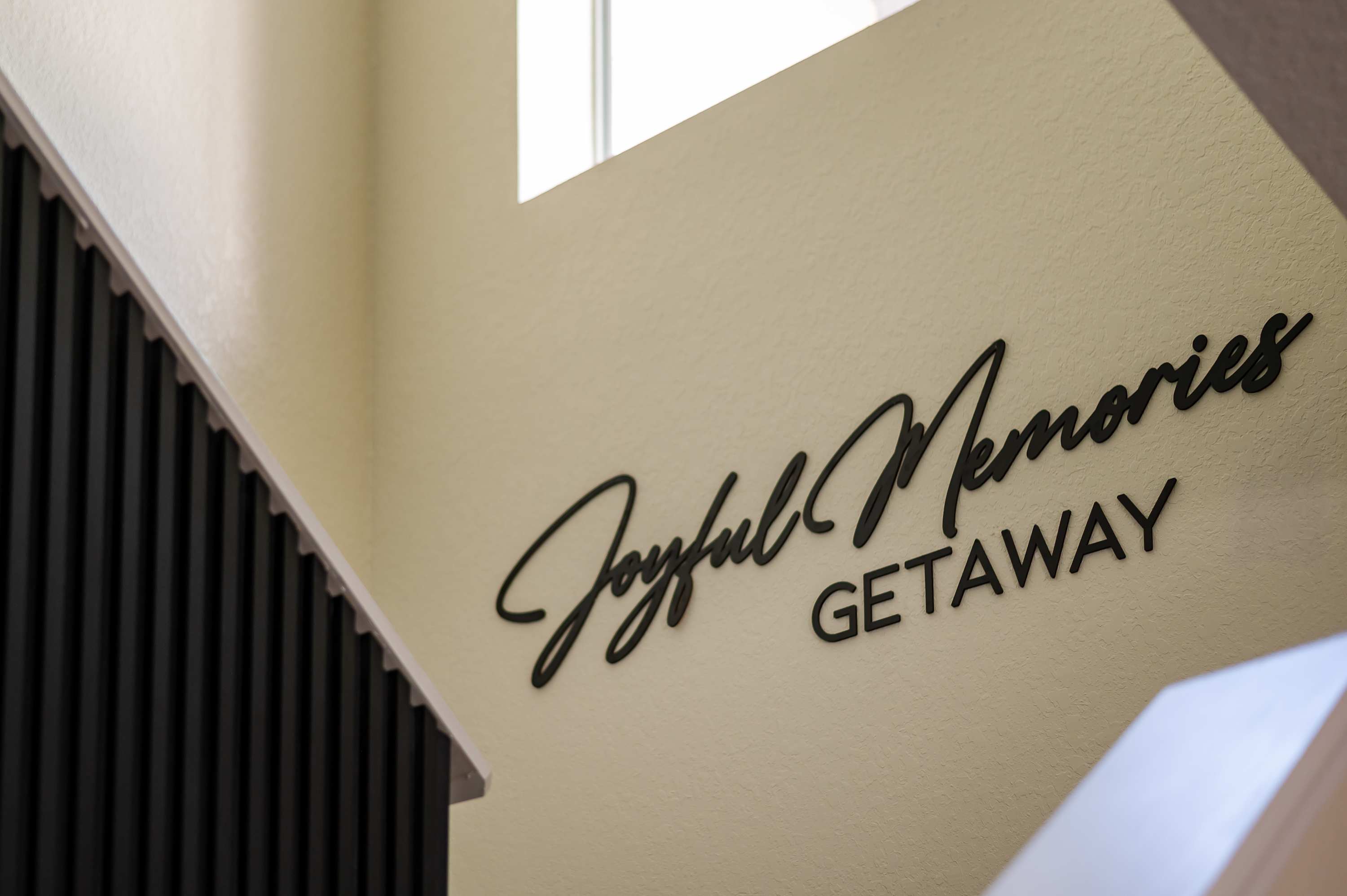 Stairway detail w/ stylish script wall art for a welcoming touch