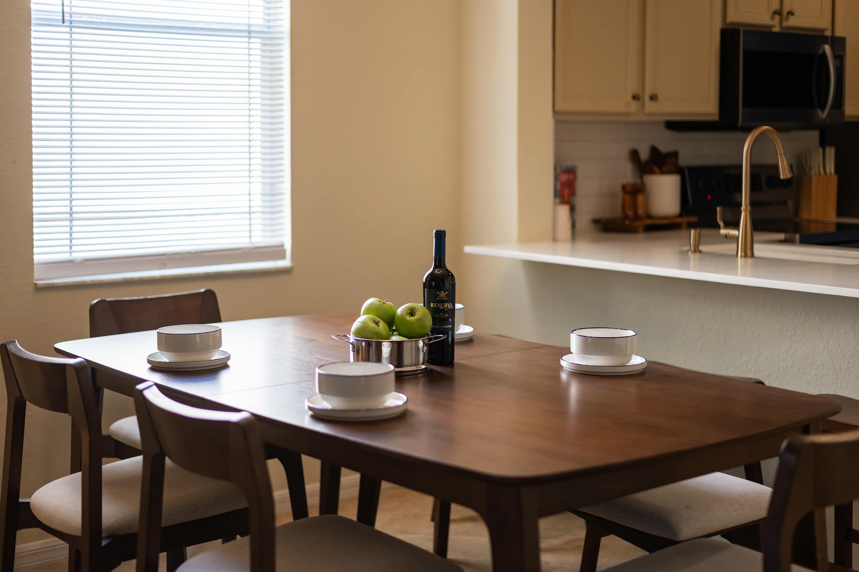Intimate dining space w/ window light & simple table setting
