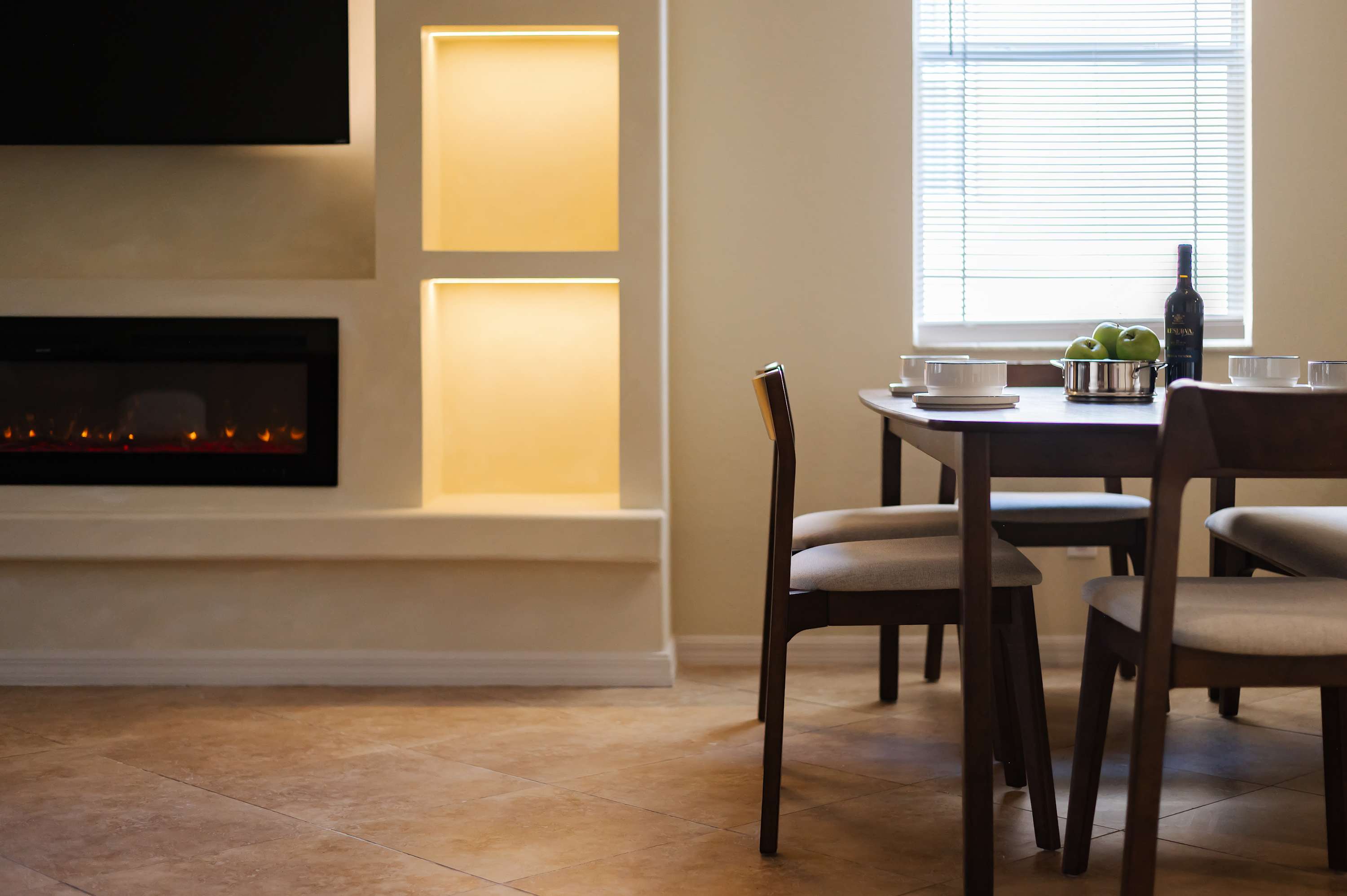 Warm dining nook beside a modern fireplace for relaxed evenings