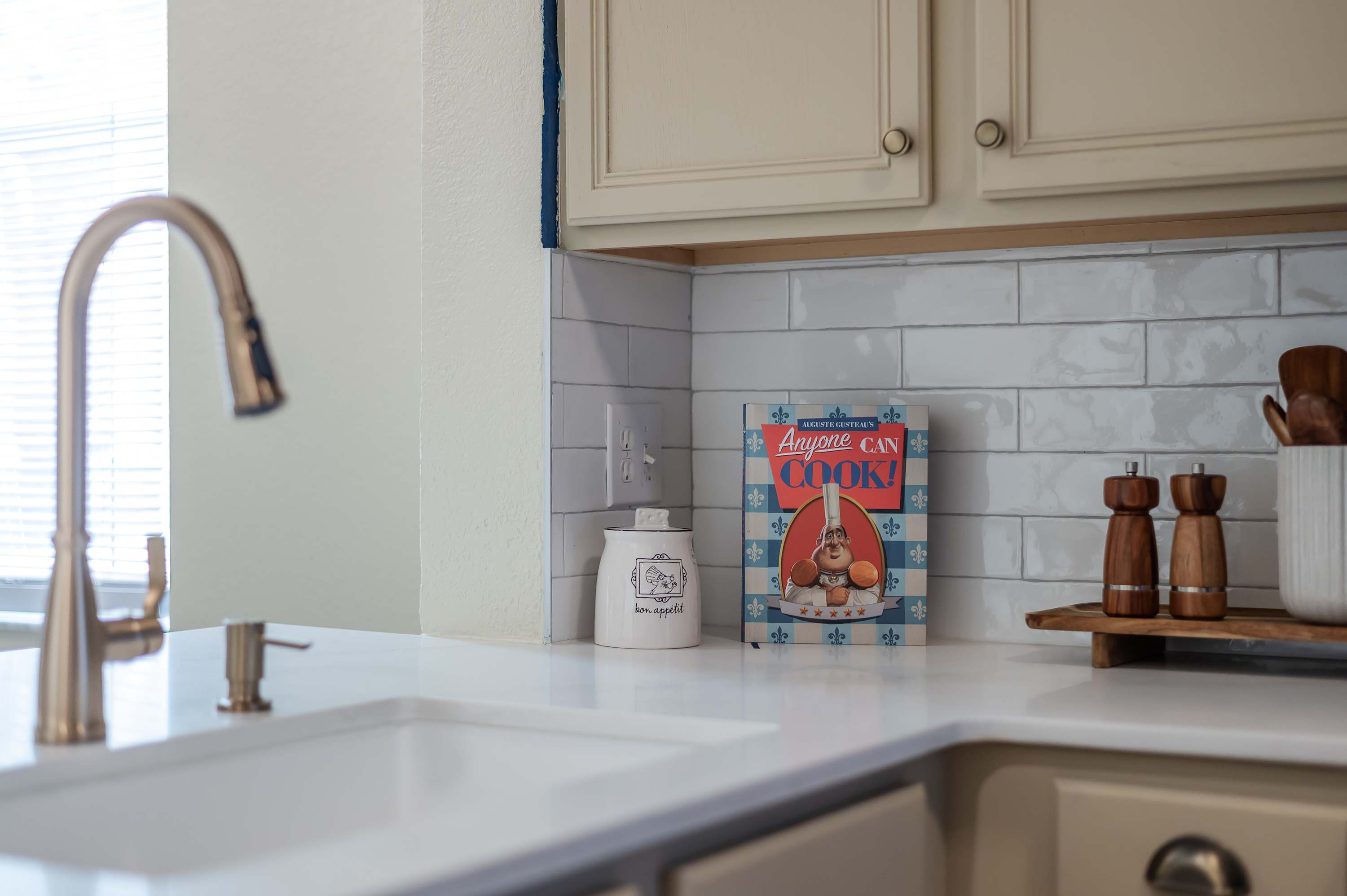 Modern sink area w/ sleek faucet & subway tile backsplash