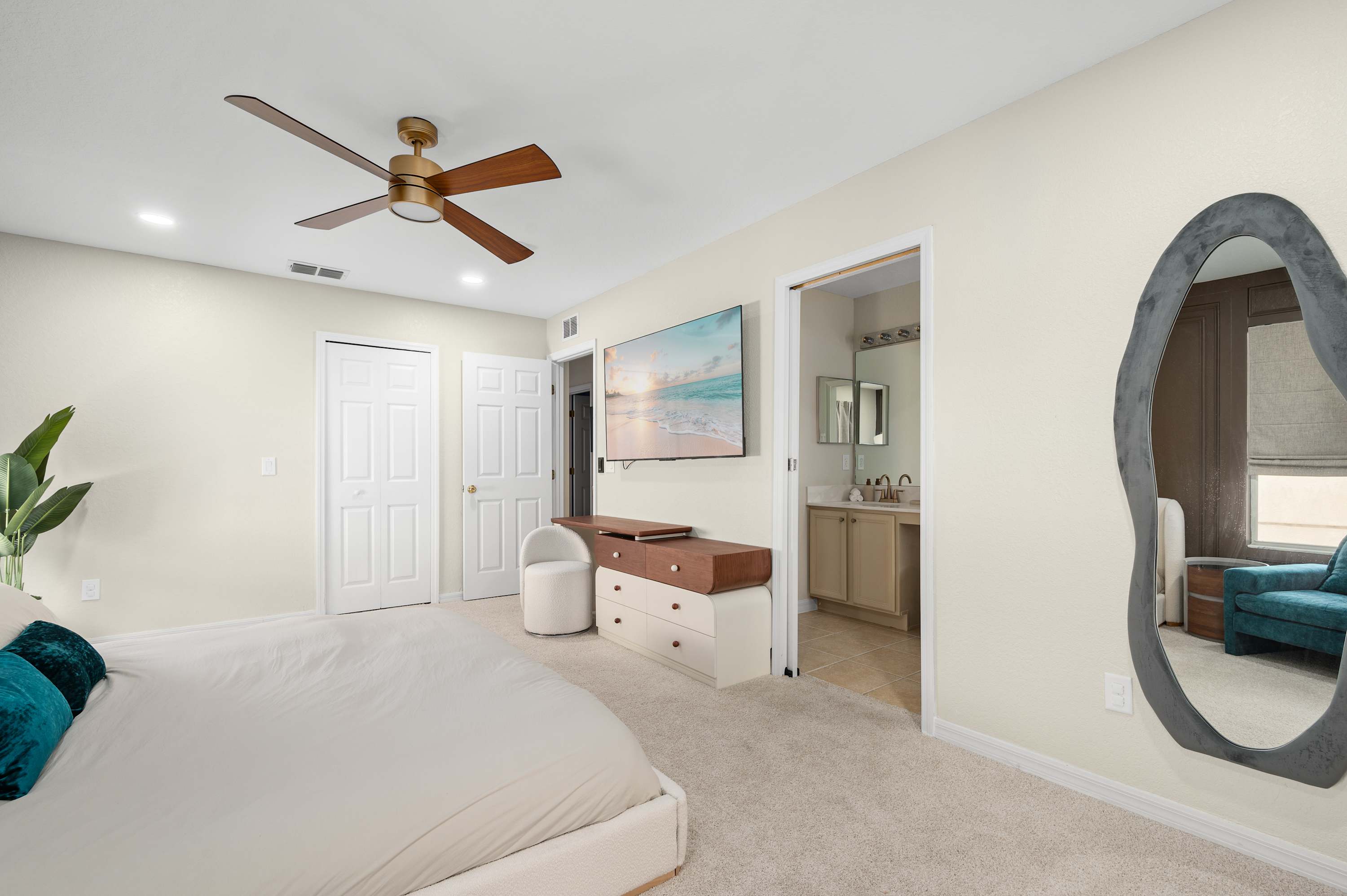 Bright master bedroom w/ plush bedding & soft neutral tones
