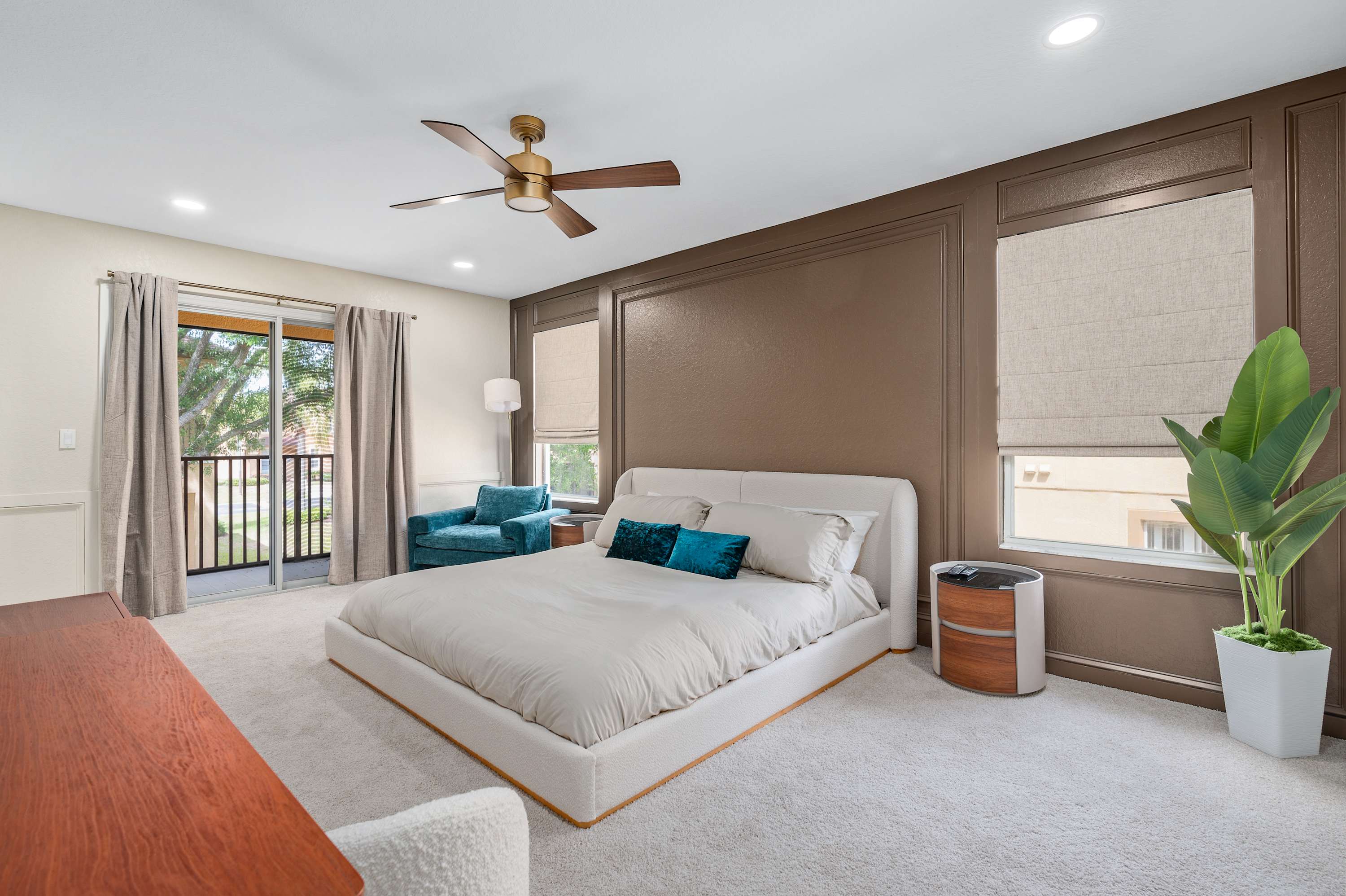 Spacious master bedroom w/ large bed, soft tones & natural light