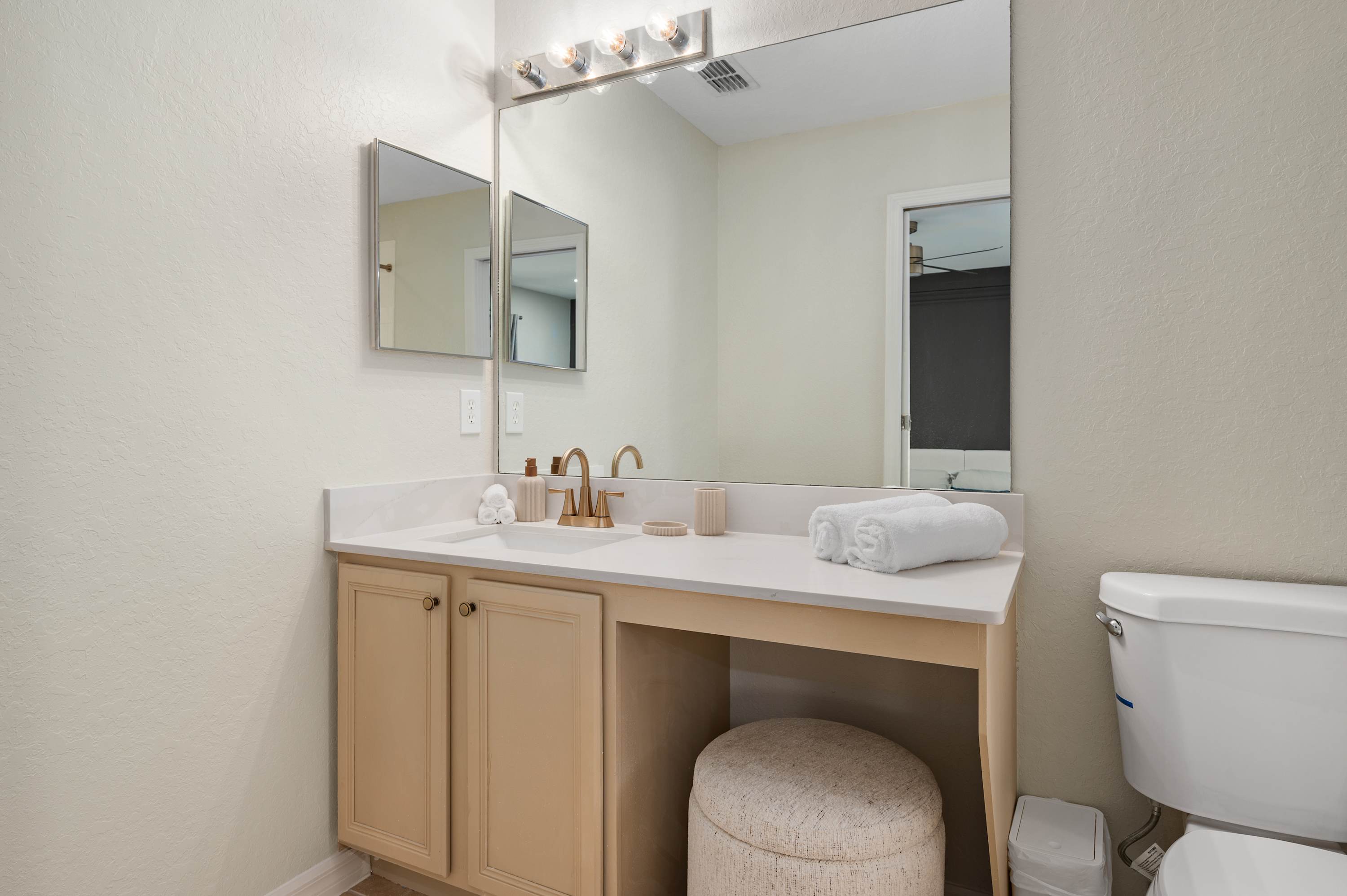 Spacious bathroom vanity w/ sink, large mirror & plenty of counter space