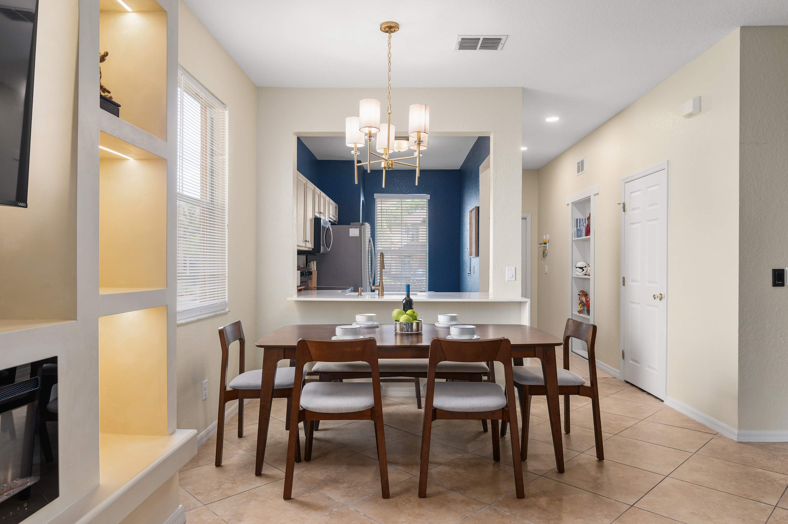 Dining area w/ statement lighting & cozy setup for shared meals