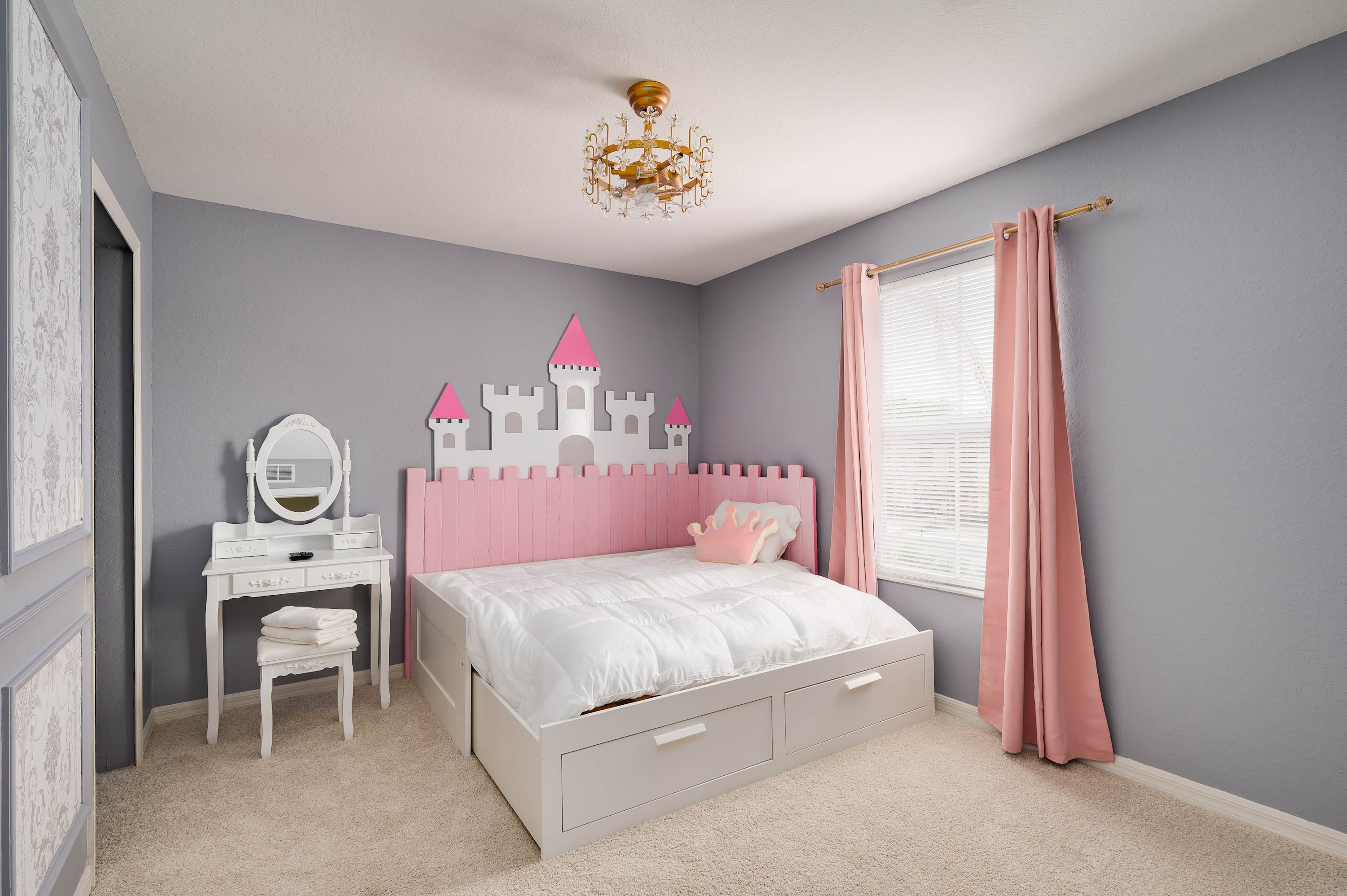 Playful princess-themed bedroom w/ soft colors & charming decor for kids