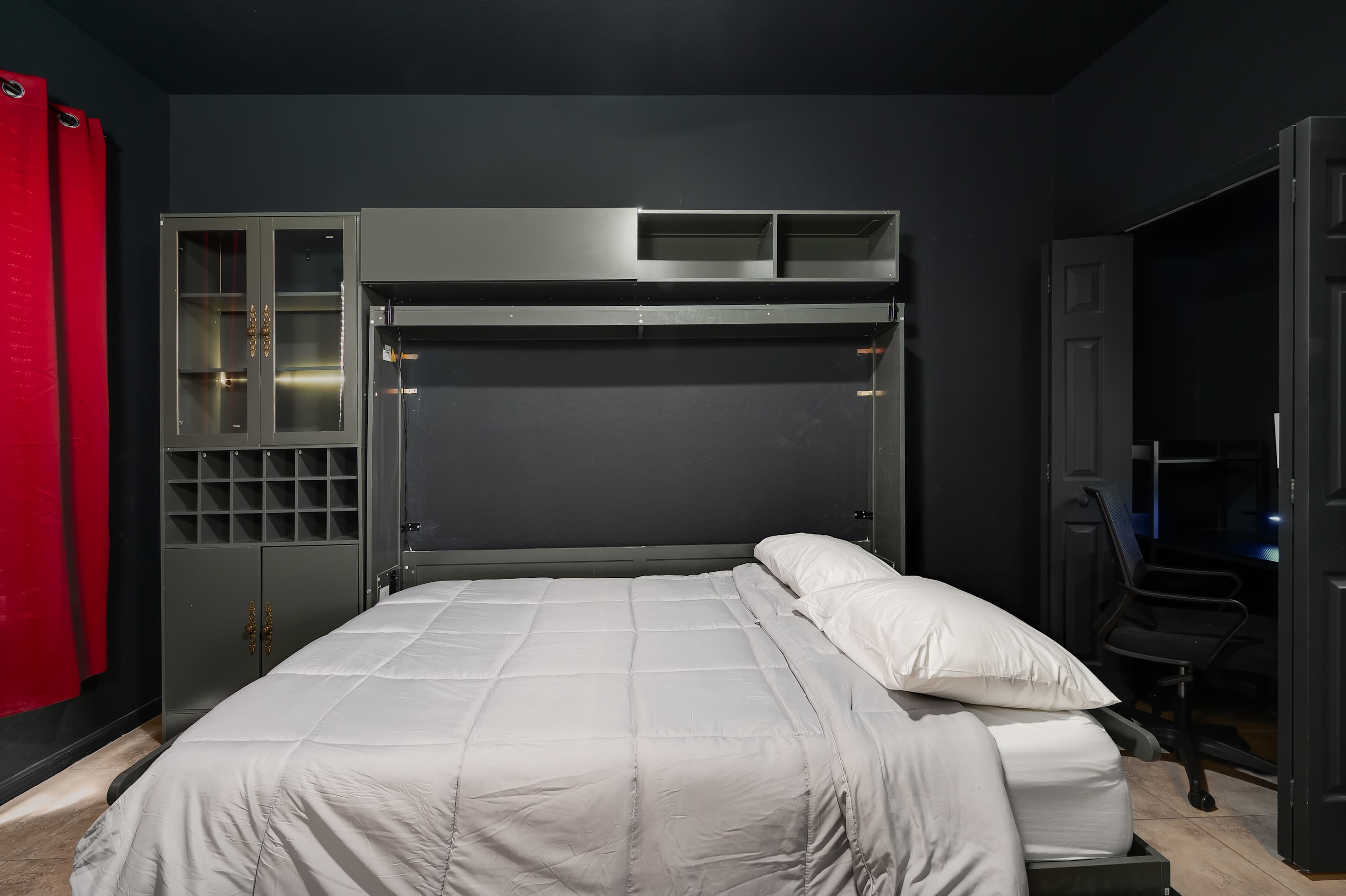 Stylish bedroom w/ fold-down bed & moody lighting for a restful stay