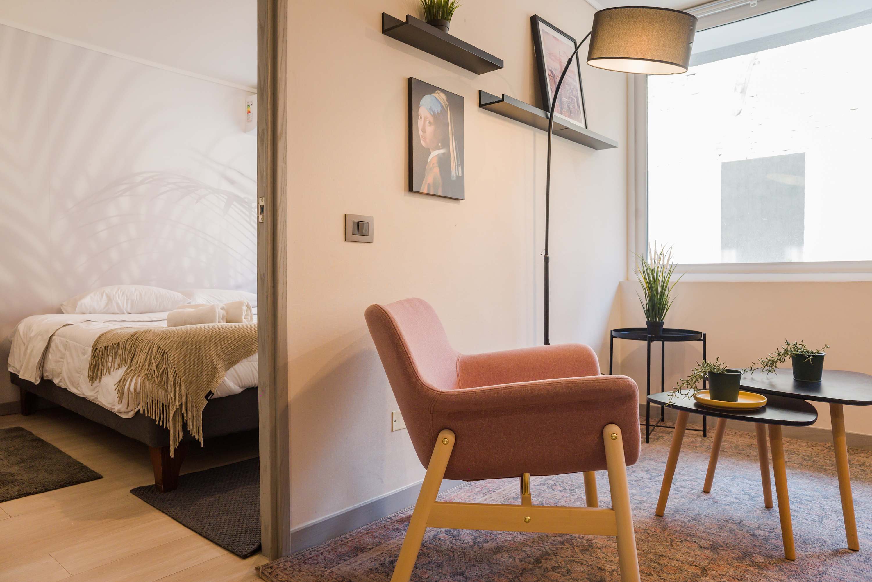 Relax in this stylish living area with modern decor and natural light, perfect for unwinding after exploring the city.