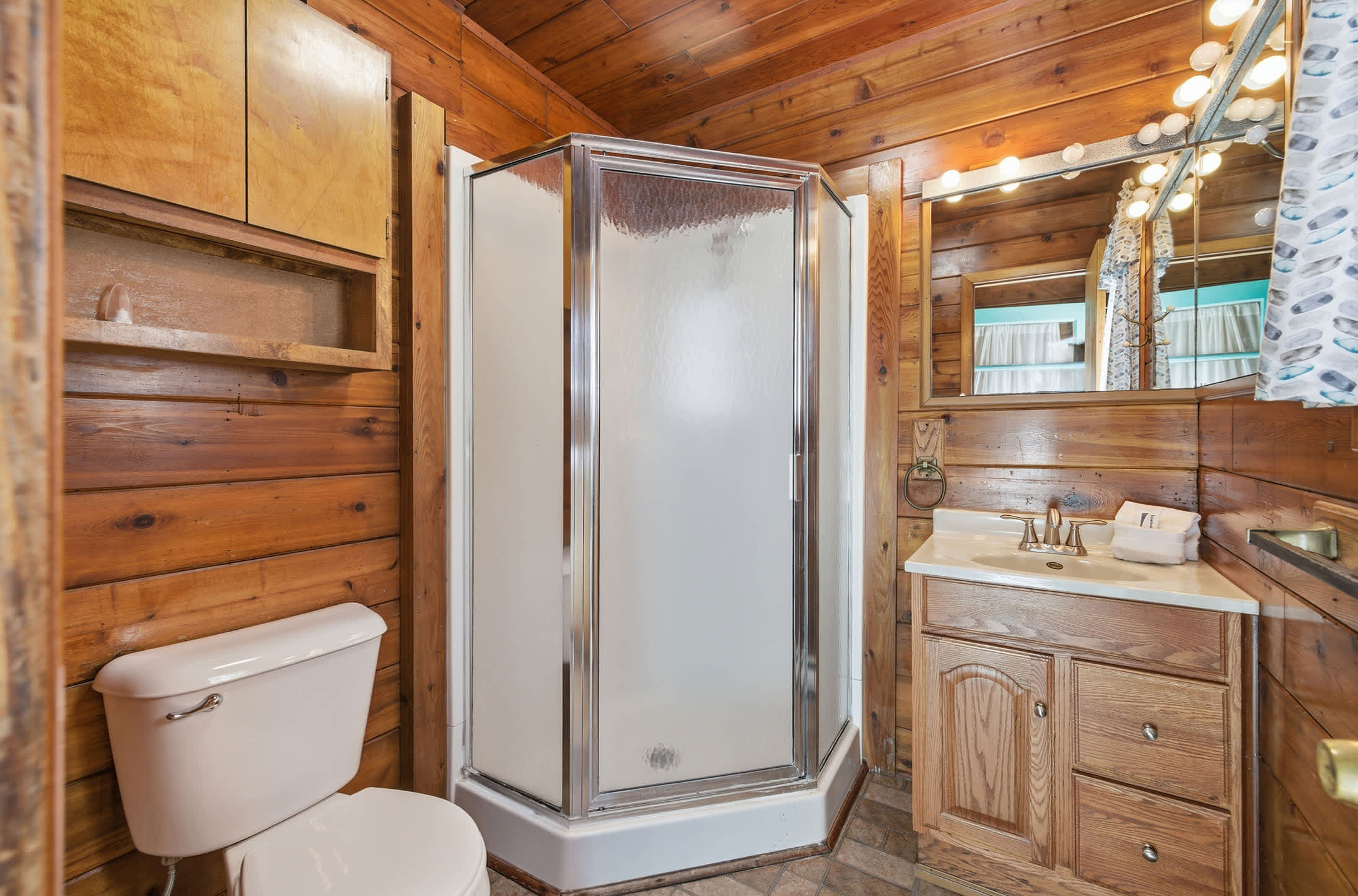 Hot shower, warm wood — the cabin way to unwind.