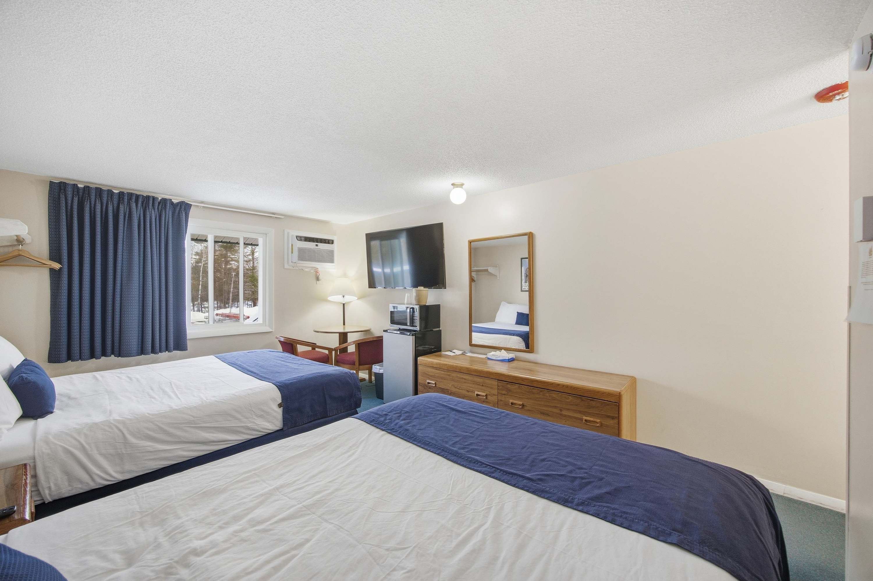 Unwind in one of Suite 215’s plush queen beds after a day on the town​