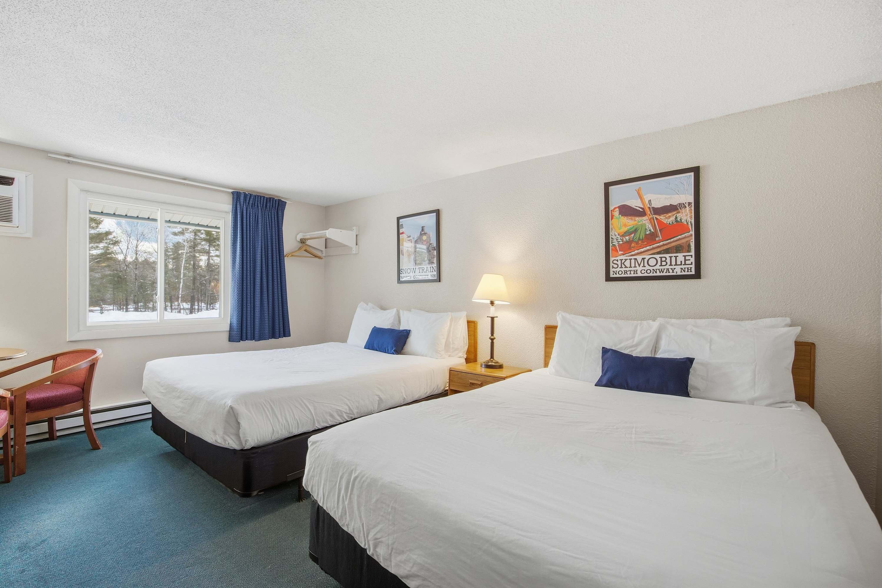 Suite 216 boasts a pair of plush queen beds, a TV, & a full bath​