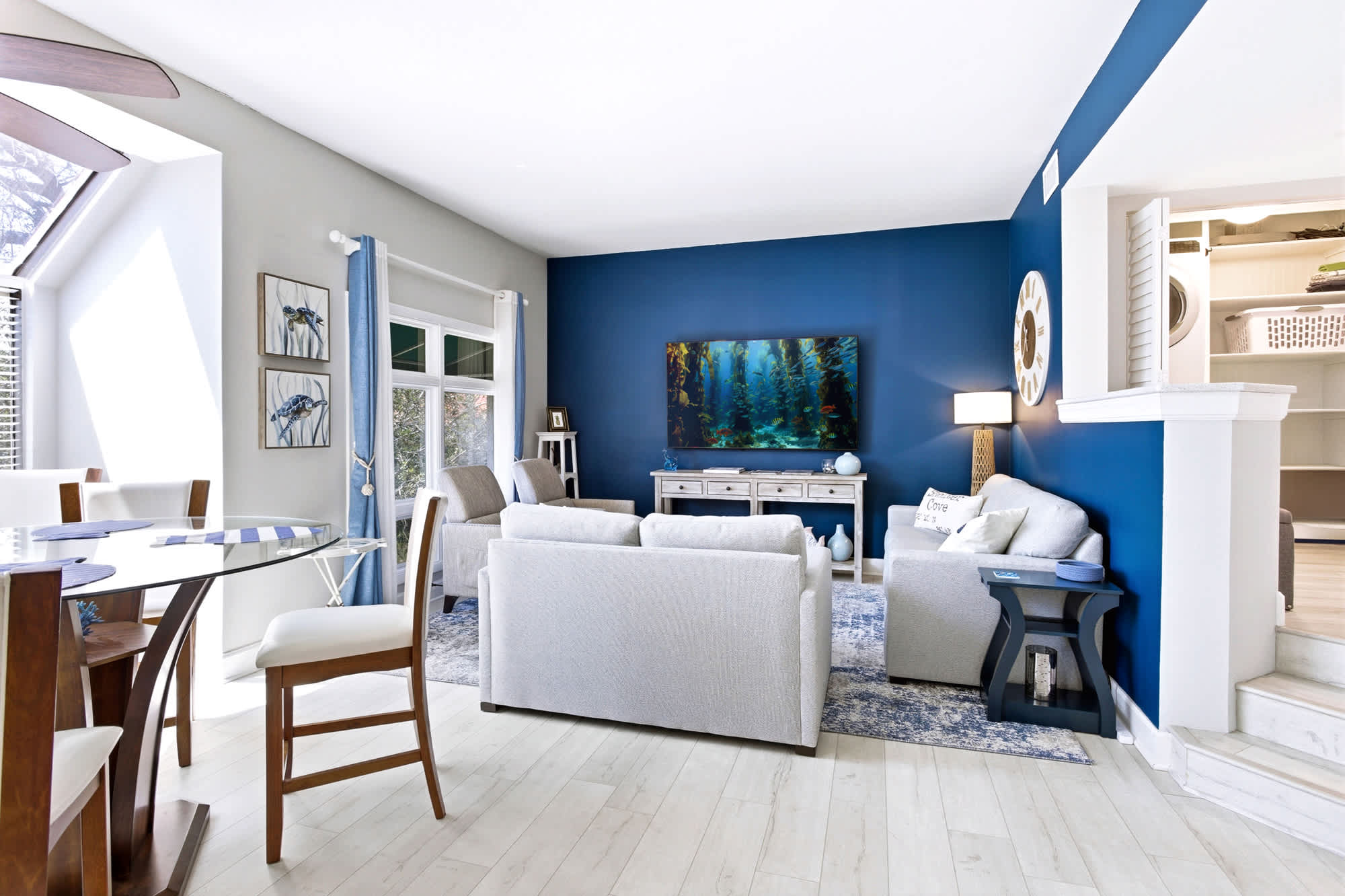 Sun-soaked living room with cathedral ceilings, plush sectional seating, and a smart TV - the heart of the home for movie nights and lazy mornings.