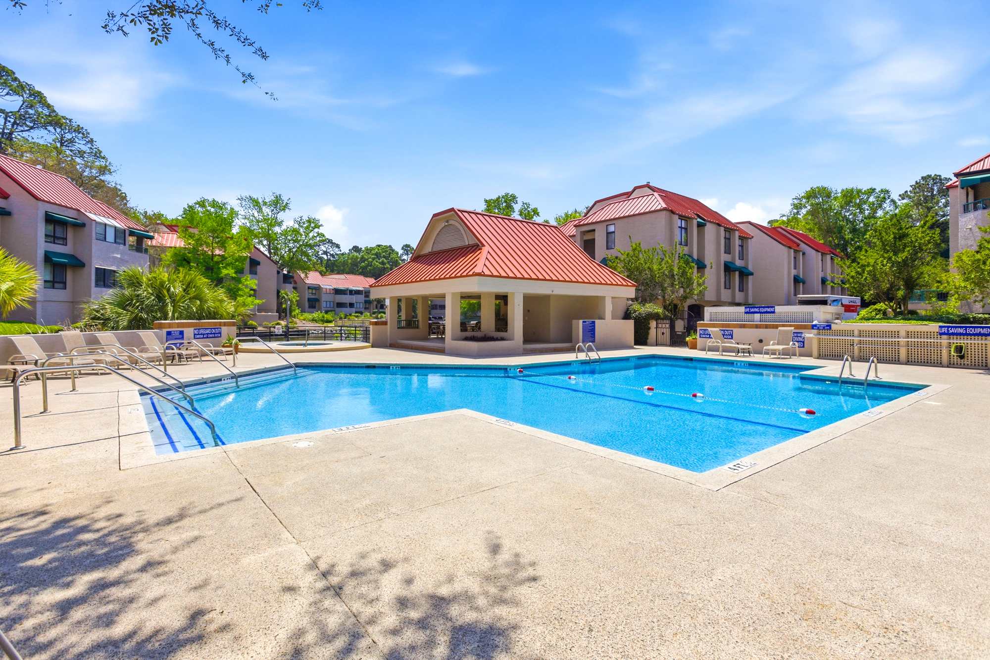 Resort-style community pool just steps from your door - loungers, room to swim, and a shaded cabana for a break.