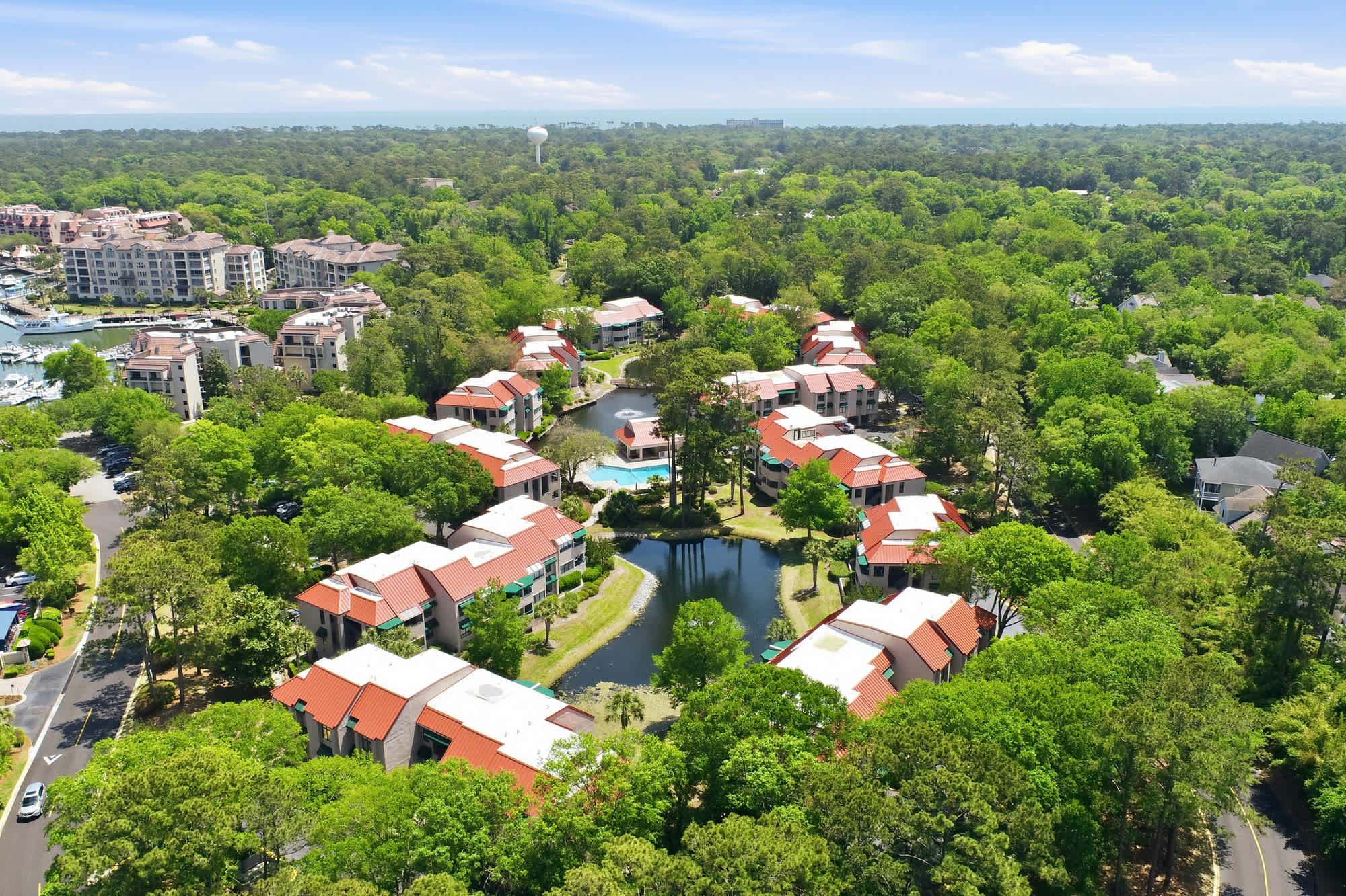 .Bird's-eye view of the property - lagoons, pool, and landscaped paths weaving the community together.