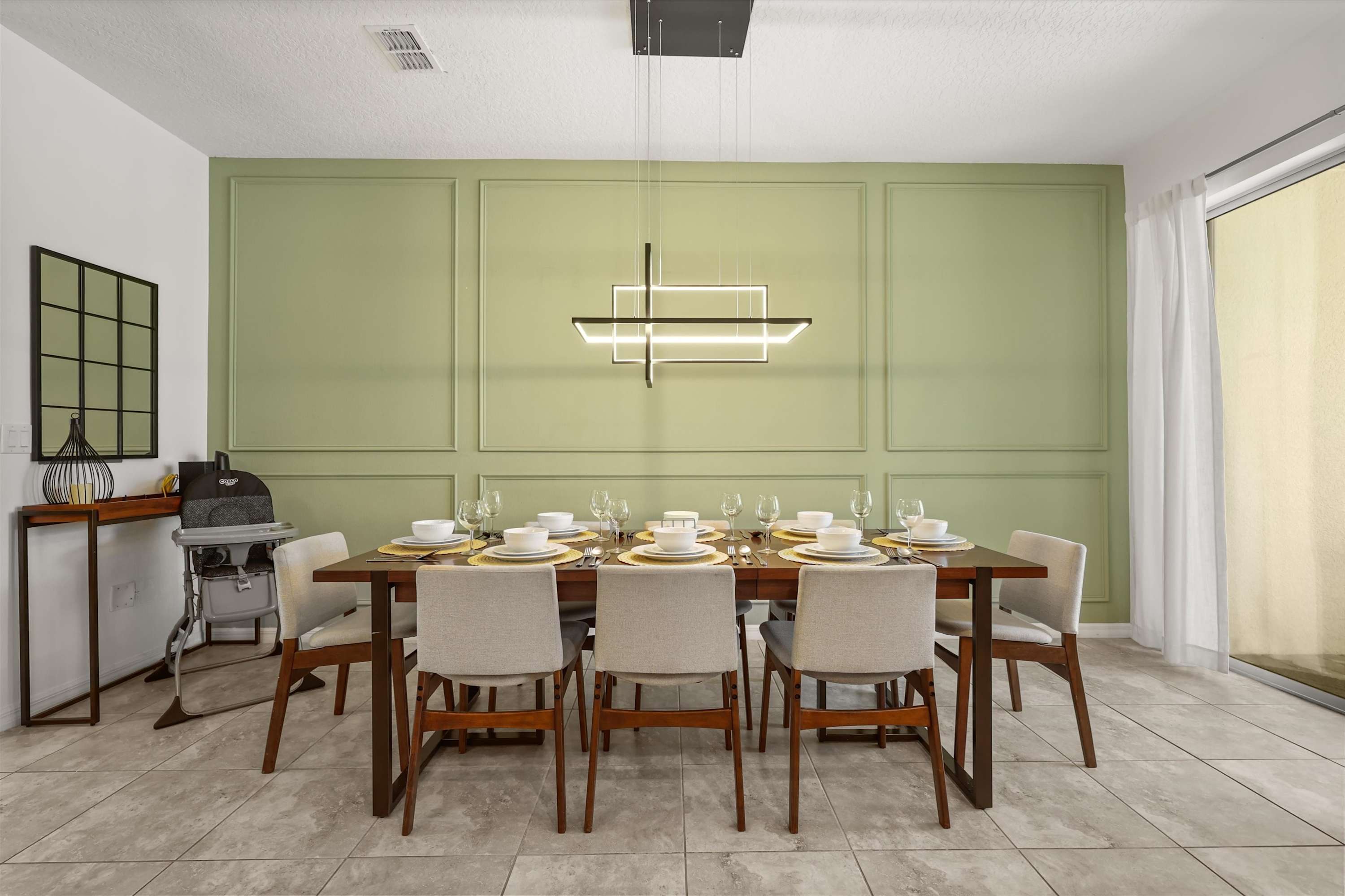 Dining area seats up to 8 guests with a high chair available for families, perfect for shared meals and easy group dining.