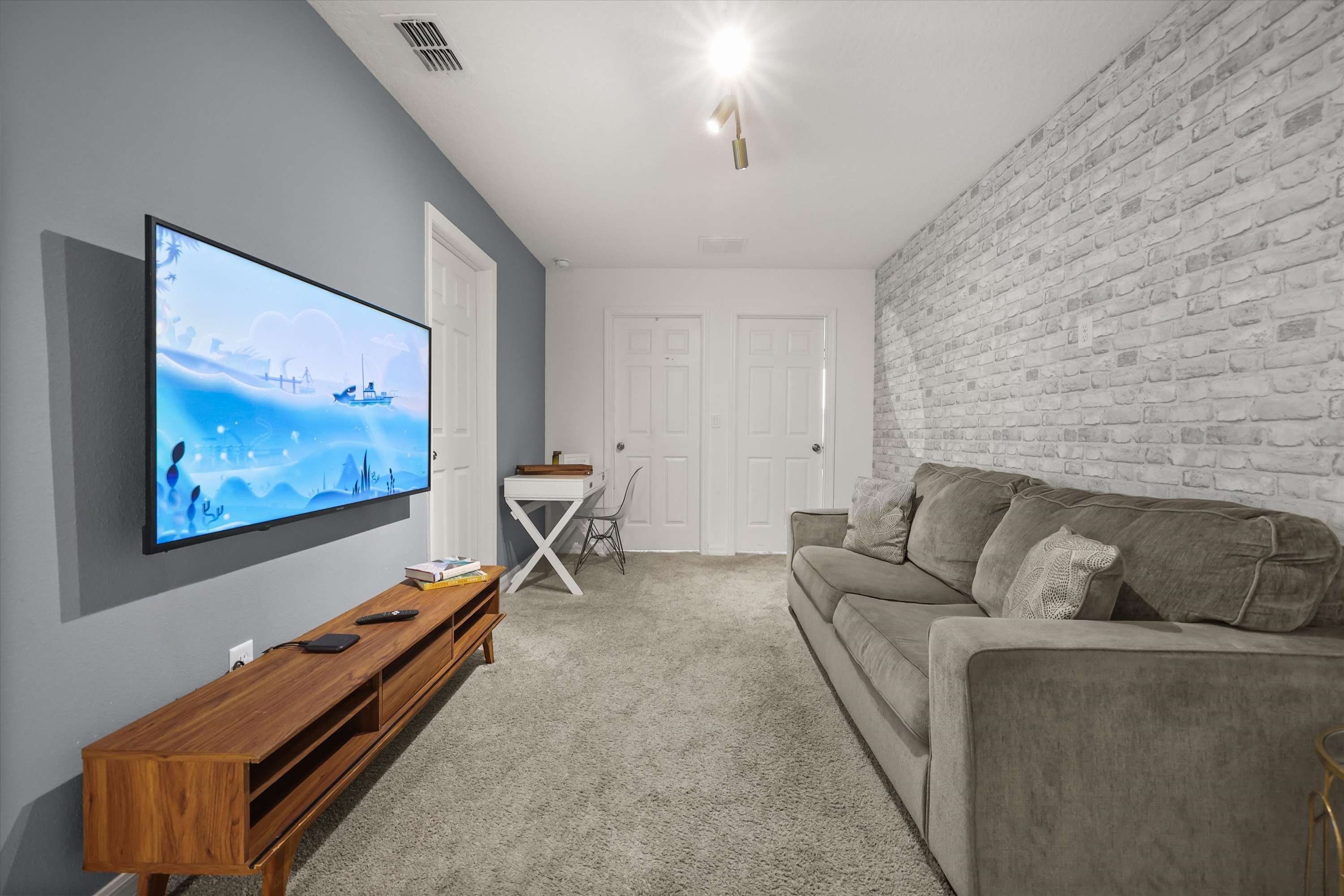 Second floor living space with couch and TV, perfect for relaxing, movie nights, and quiet downtime.