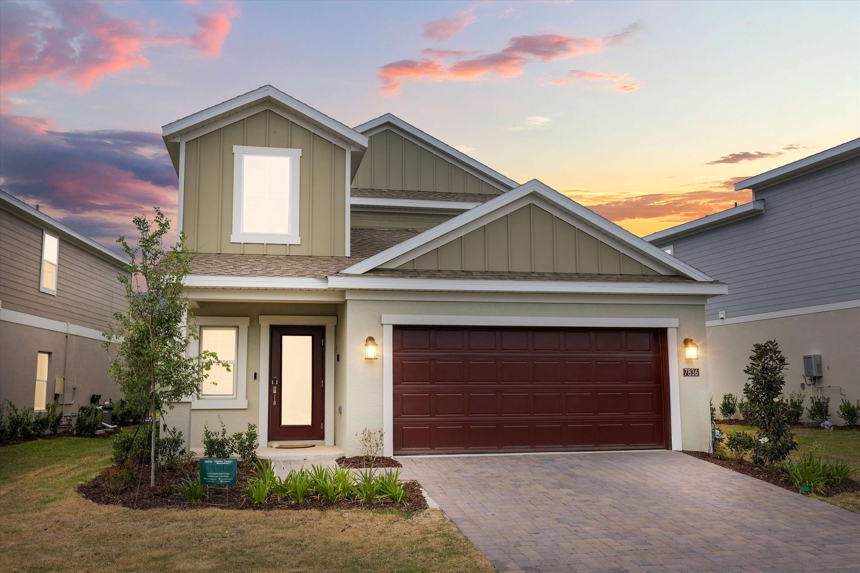 Exterior with garage and driveway parking, ideal for convenient and secure vehicle access