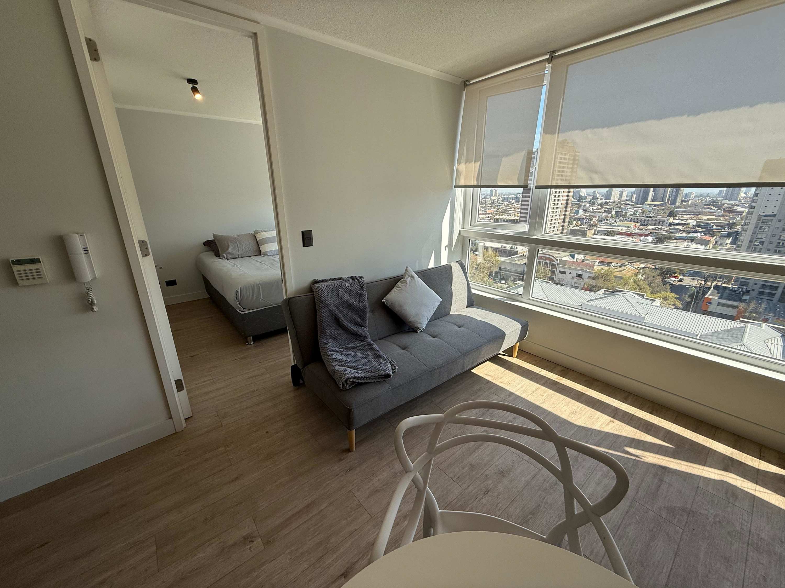 Enjoy stunning city views from this cozy living area with modern furnishings and ample natural light.