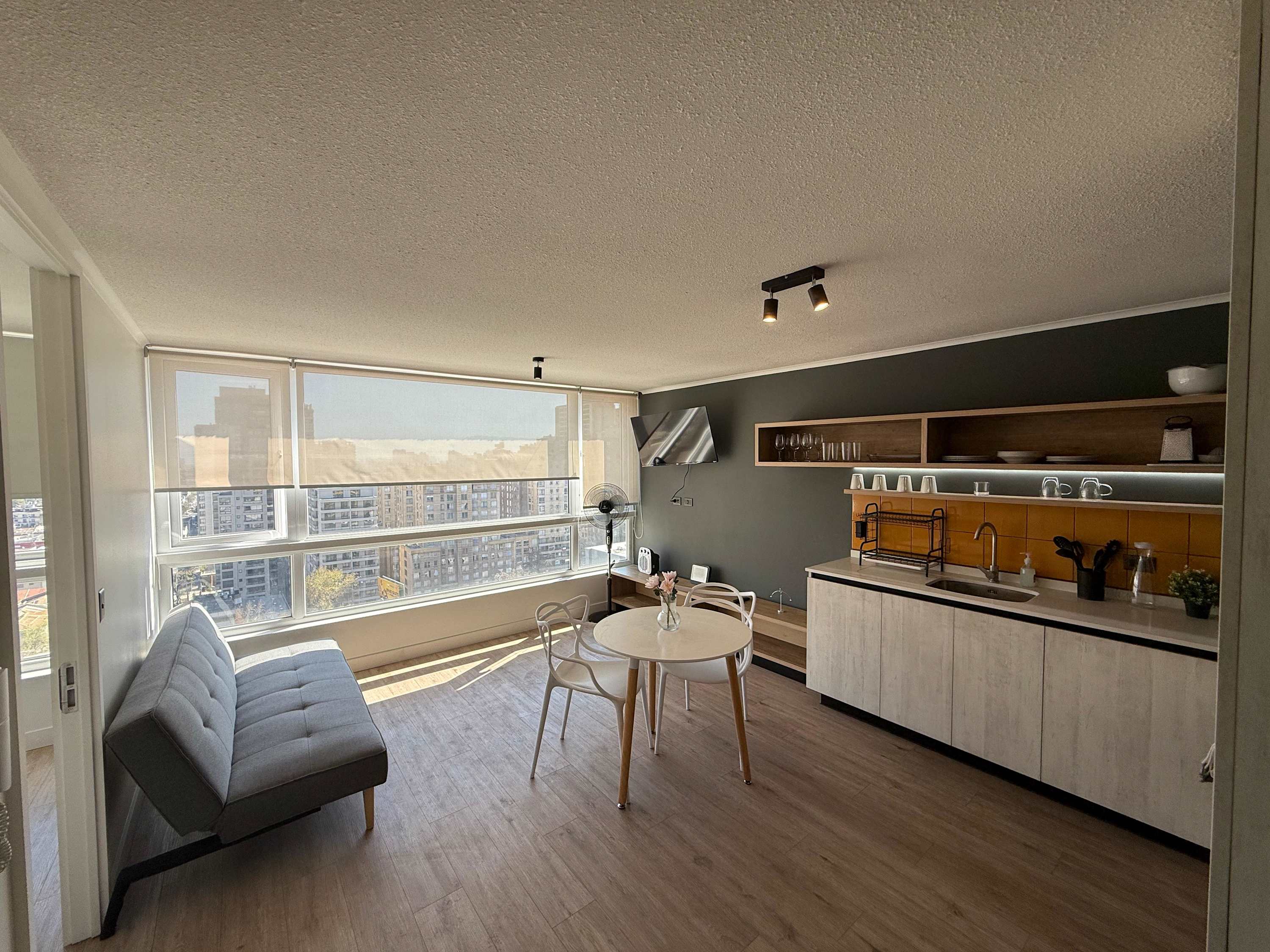 Enjoy stunning city views from this modern studio with a cozy living area and sleek kitchenette.