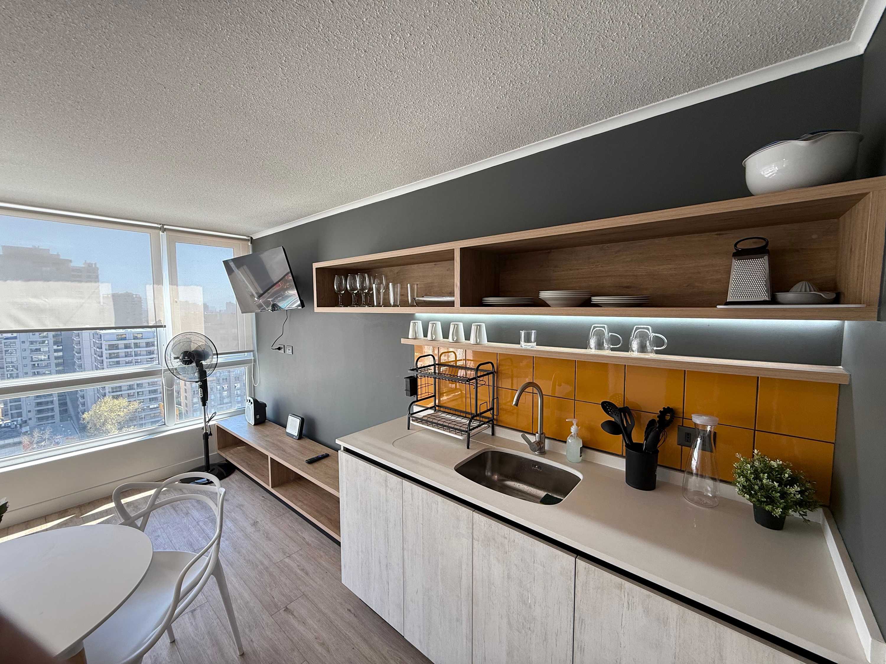 Modern kitchen with city views, perfect for cozy meals and relaxation.