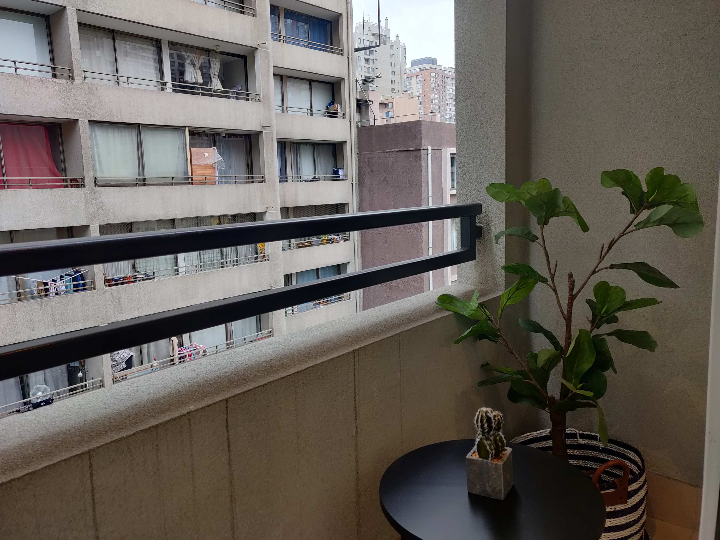 Cozy private balcony with city views, perfect for a morning coffee or evening relaxation.