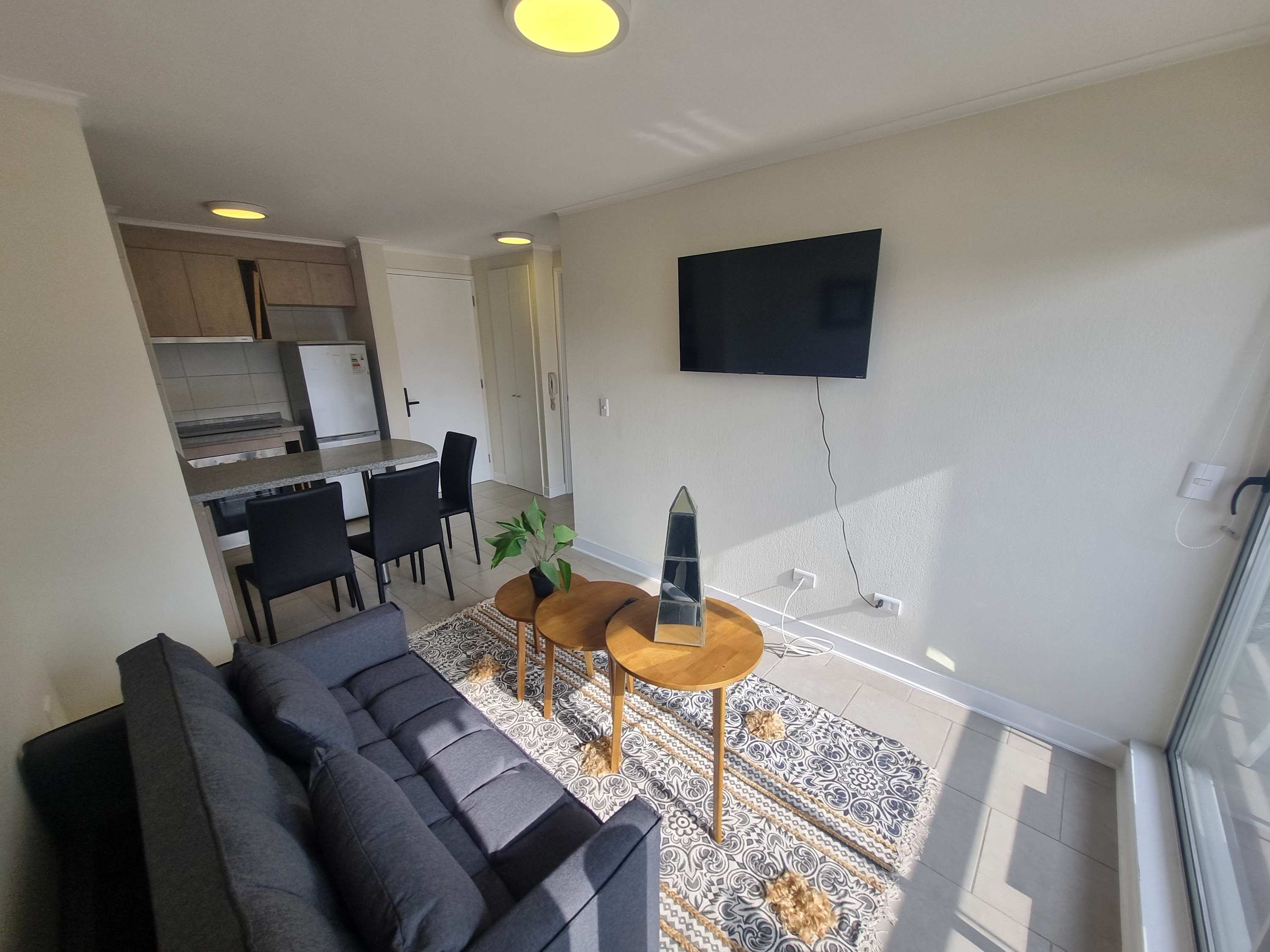 Cozy living area with modern decor, natural light, and a convenient dining space perfect for relaxing or entertaining.