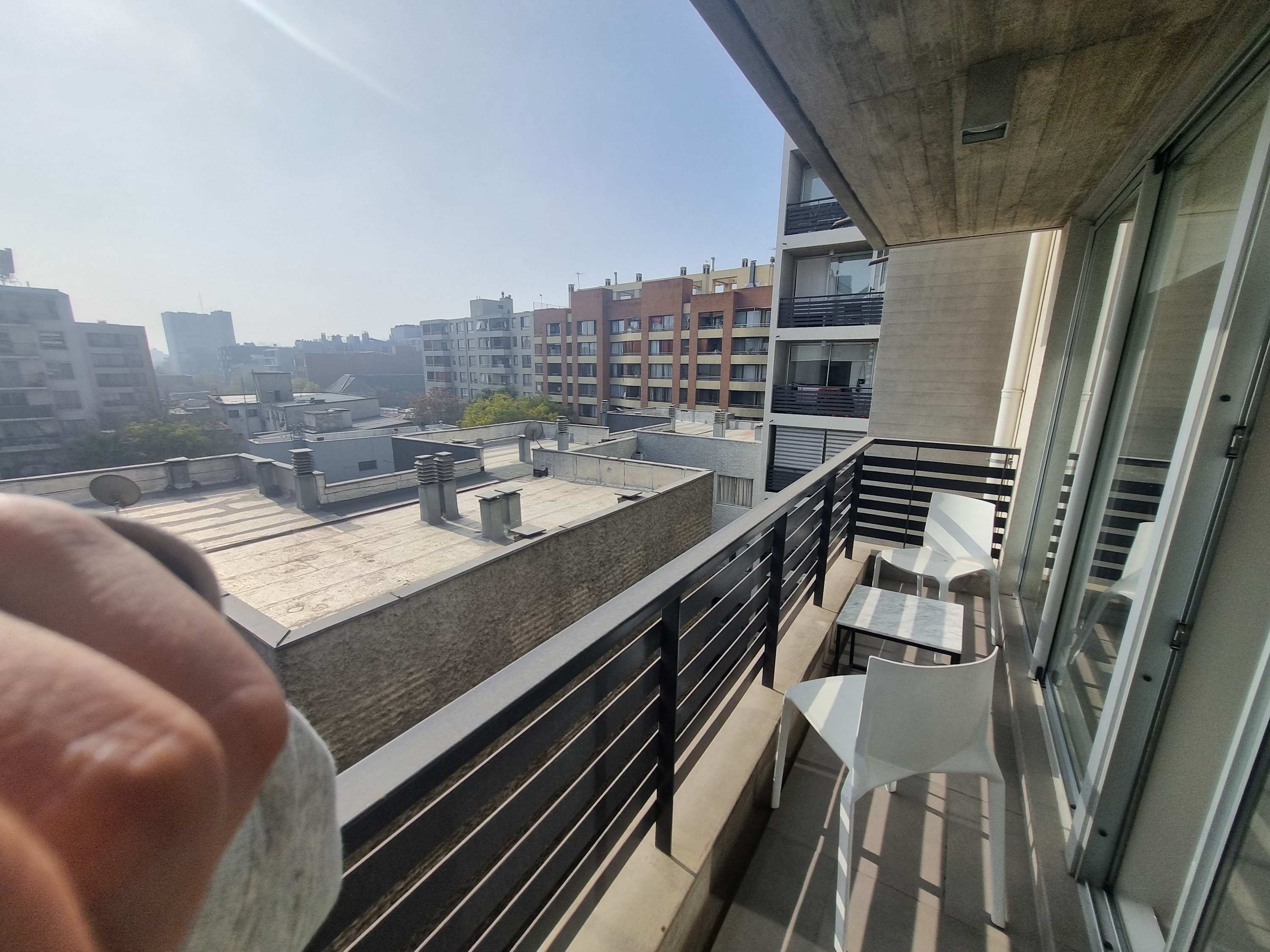 Enjoy your morning coffee with a city view from this cozy balcony, perfect for relaxation.