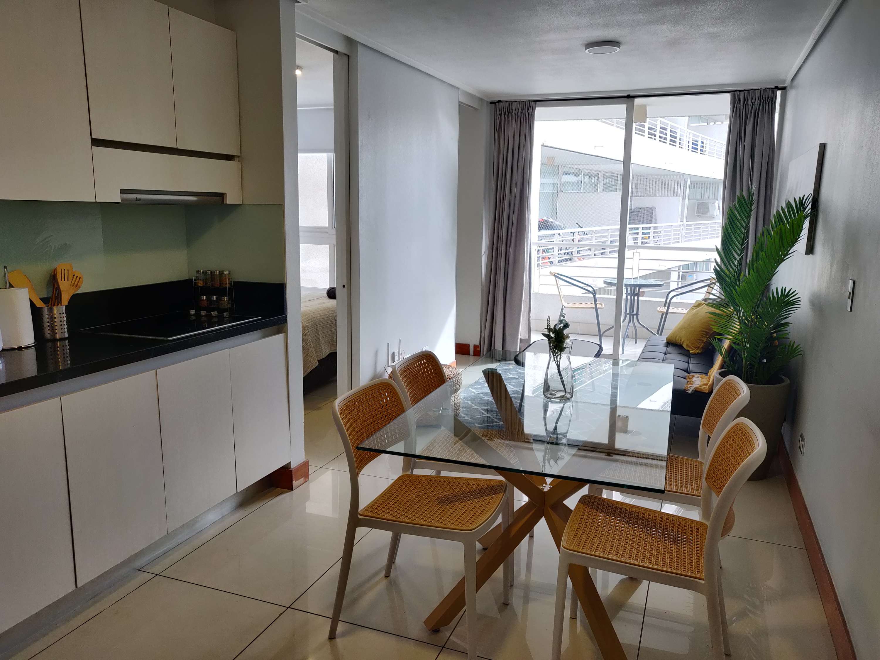 Bright and modern dining area with balcony access, perfect for enjoying meals with a view.