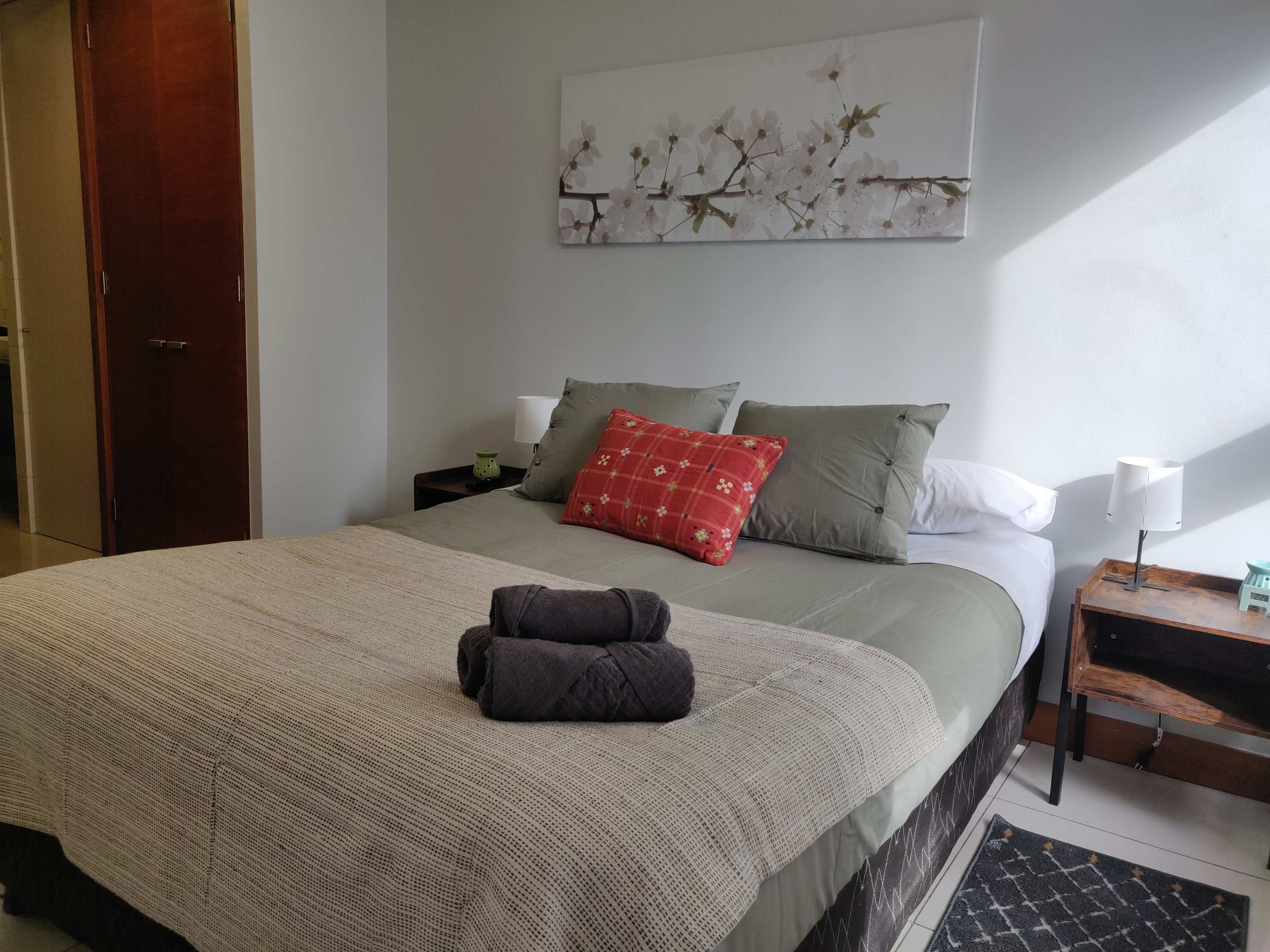 Cozy and inviting bedroom with plush bedding and natural light, perfect for a restful stay.