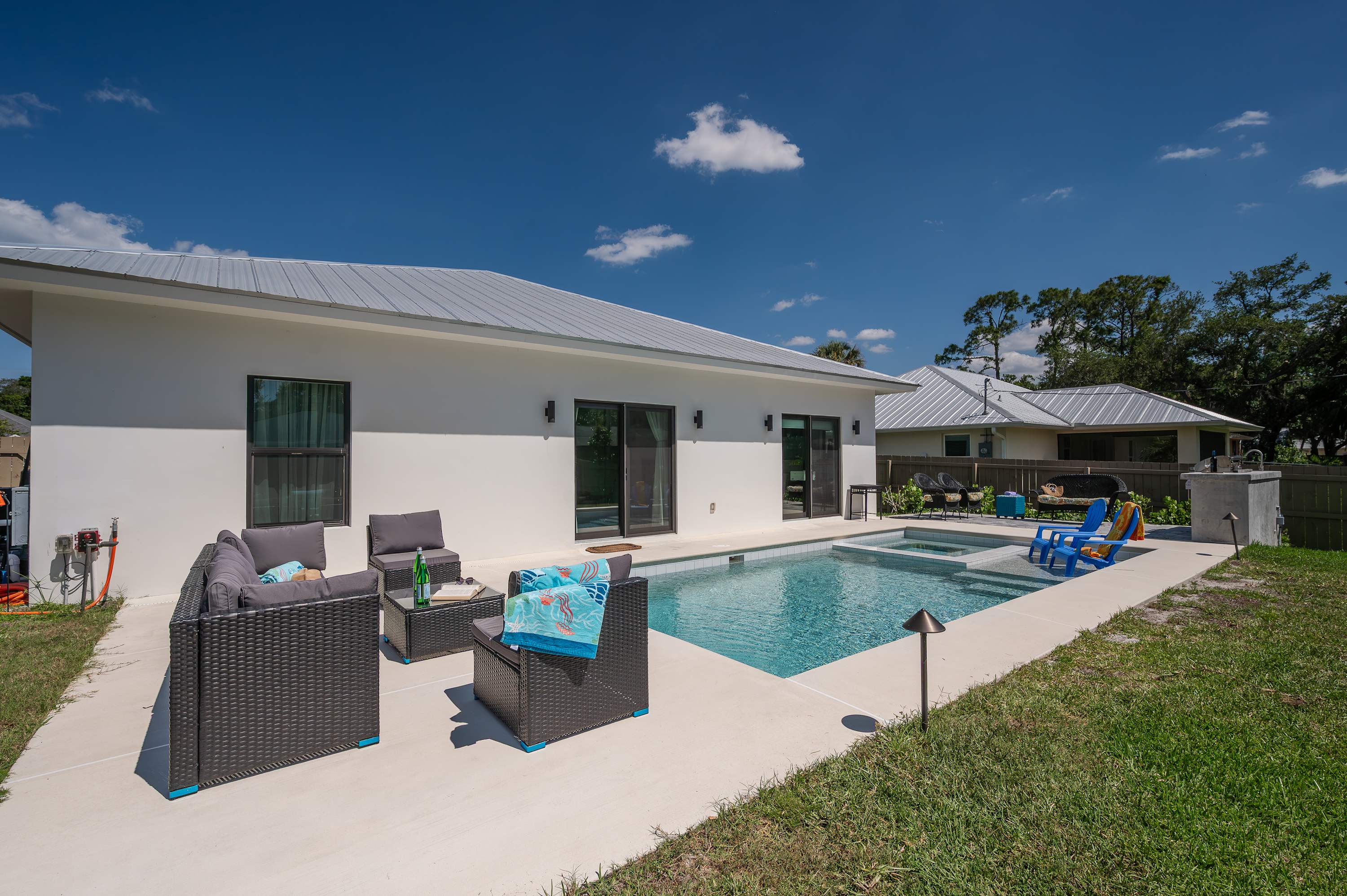 Modern backyard with a pool and outdoor seating area for relaxing.