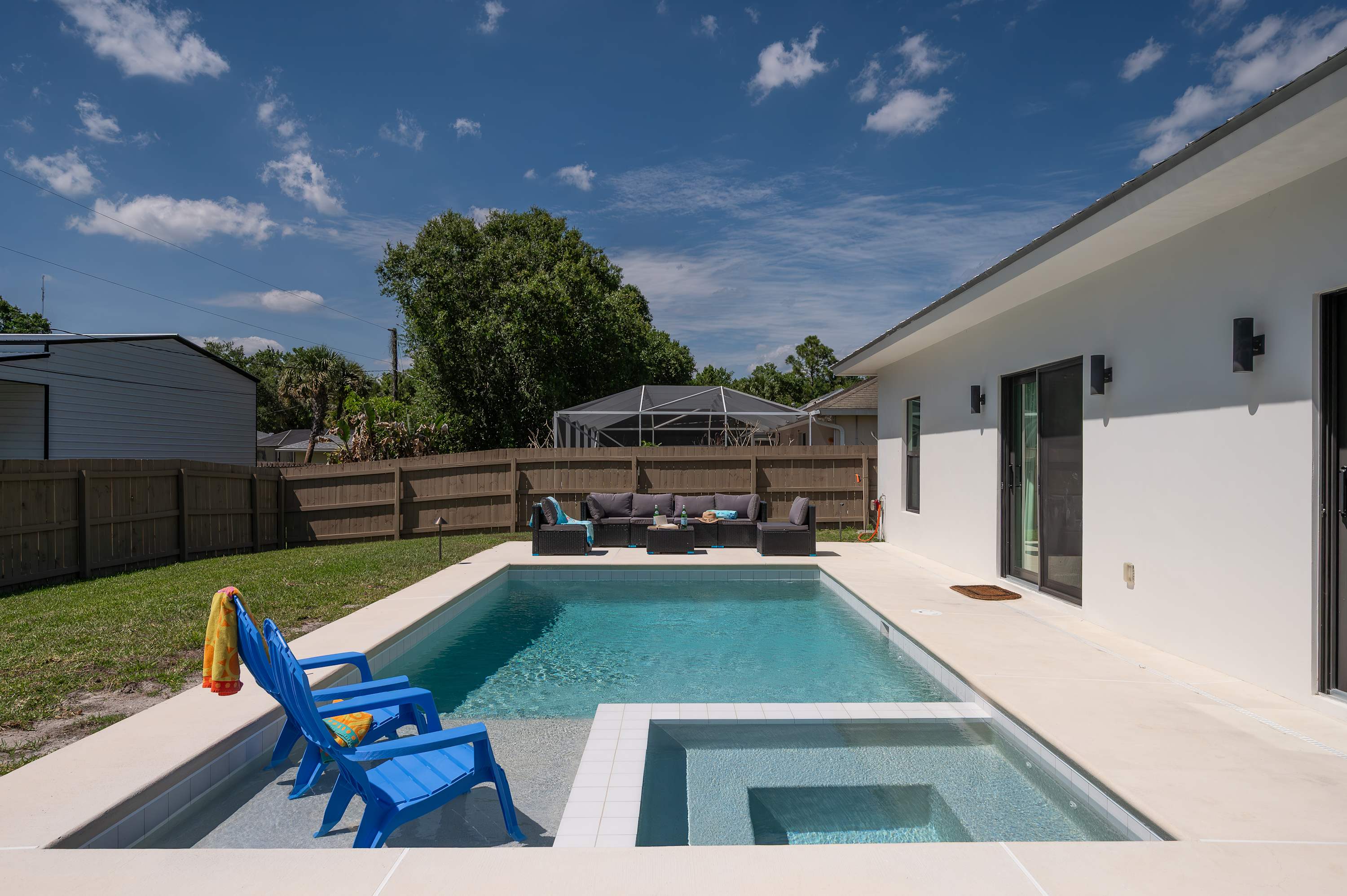 Modern backyard with a private pool and seating area for relaxing outdoors.