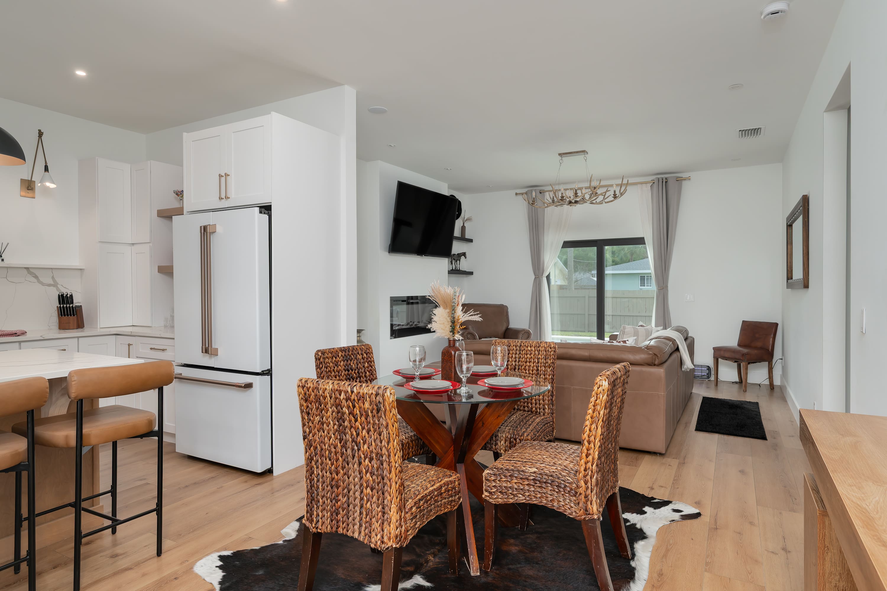 Open-concept living and dining area with natural light and modern furnishings.