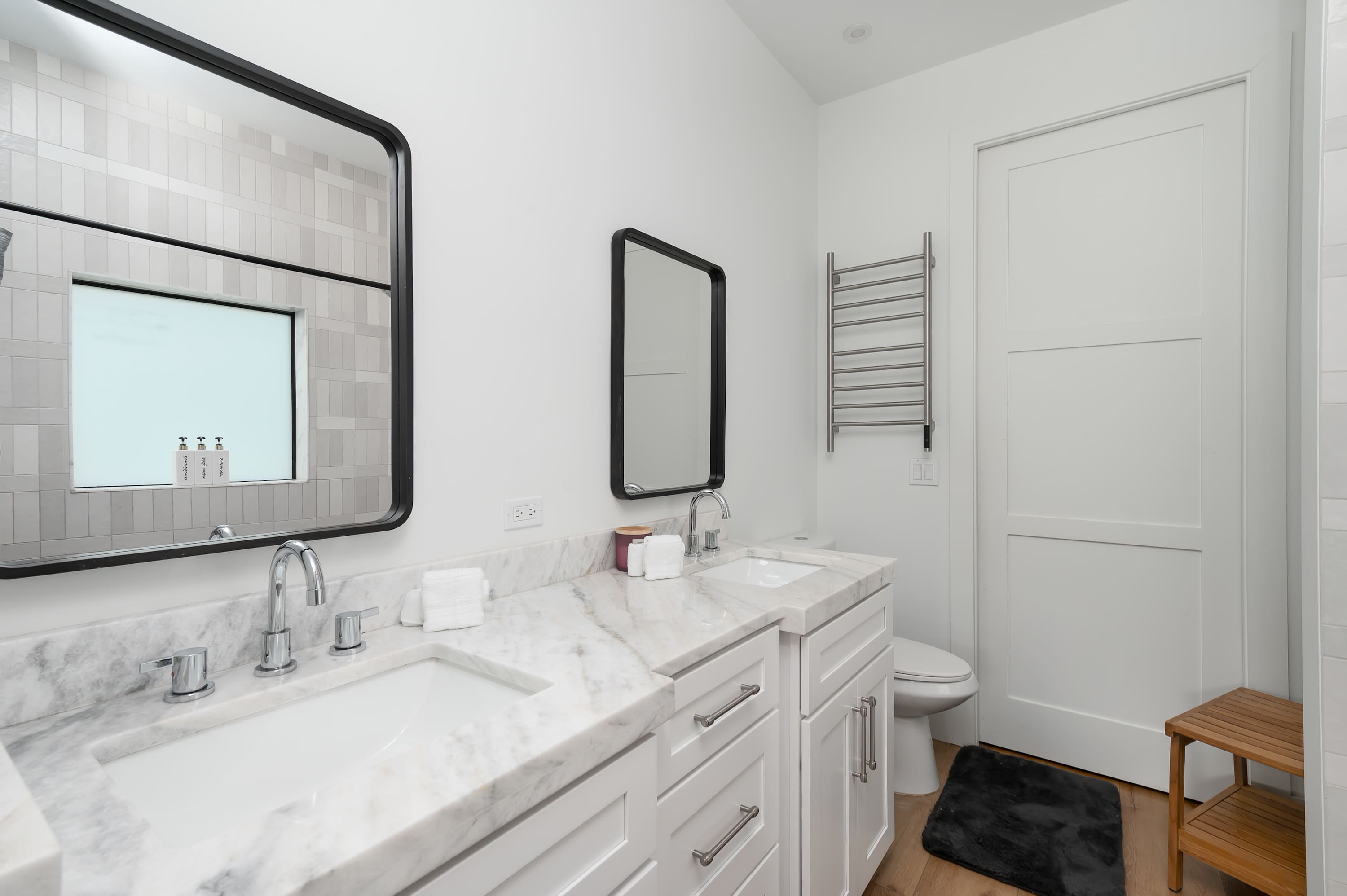 Modern bathroom with dual sinks and marble countertops for a comfortable stay