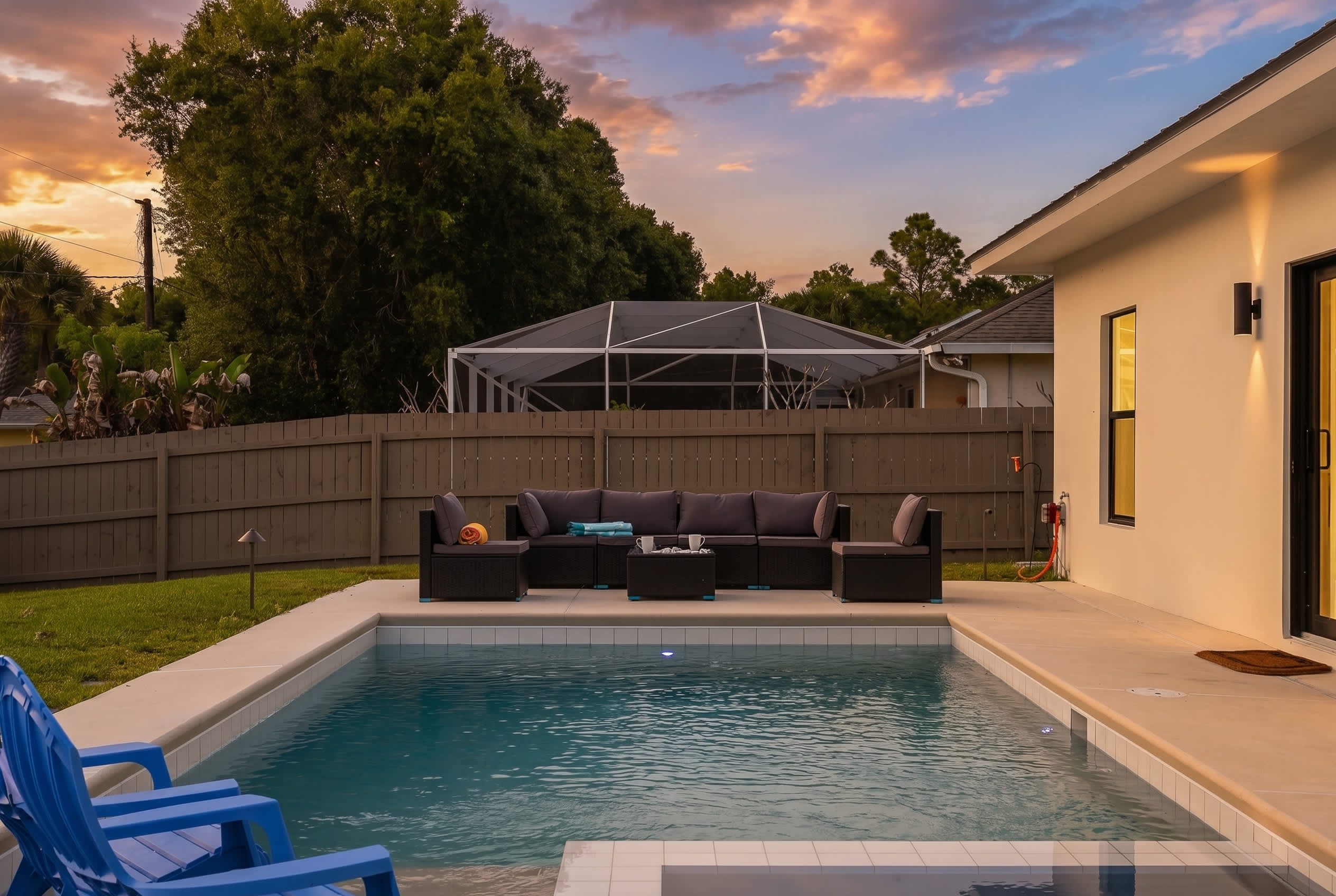 Relax by the private pool with comfortable outdoor seating at sunset.