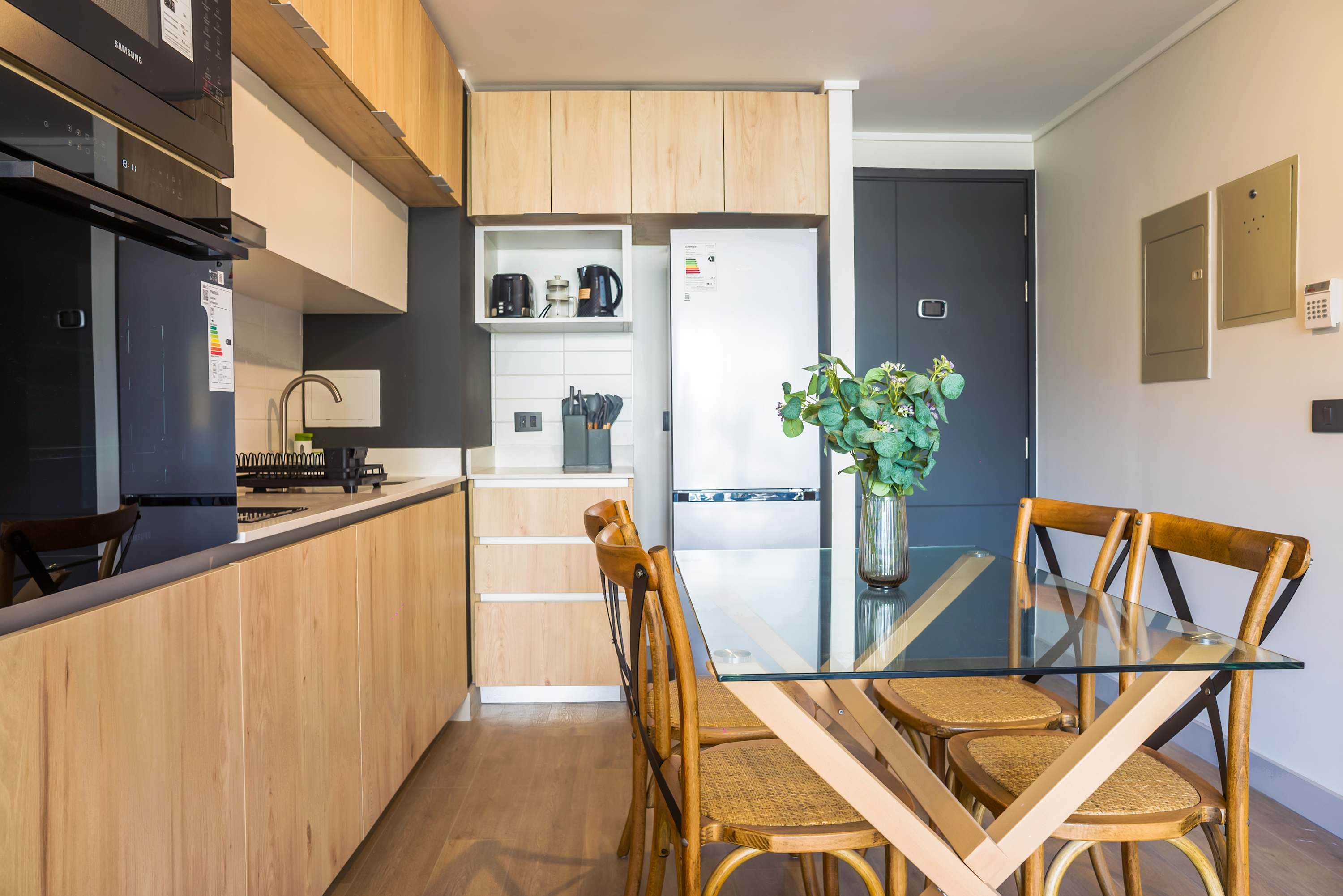 Stylish and modern kitchen with sleek appliances and a cozy dining area, perfect for enjoying meals.