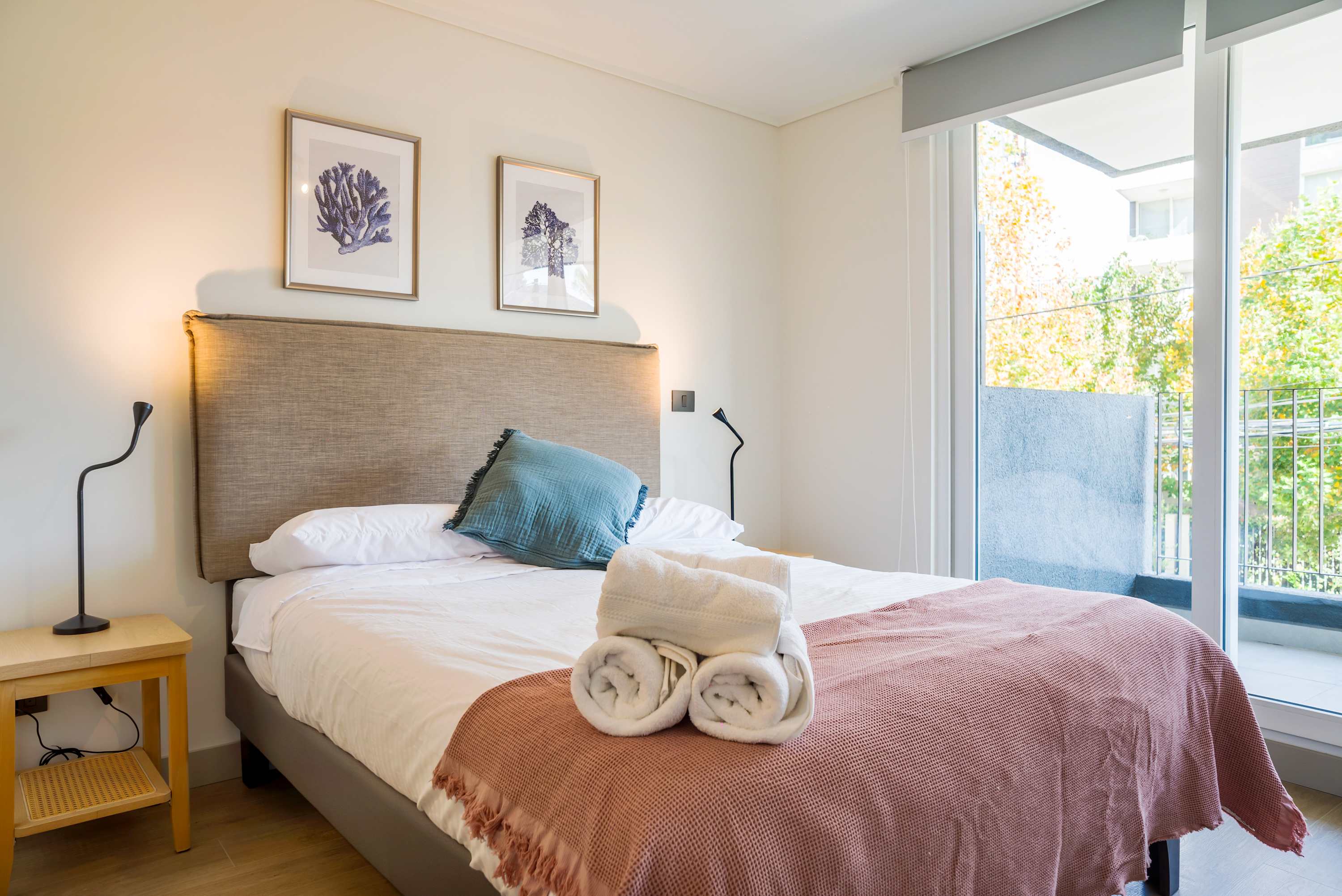 Relax in this bright and cozy bedroom with a private balcony and serene views.