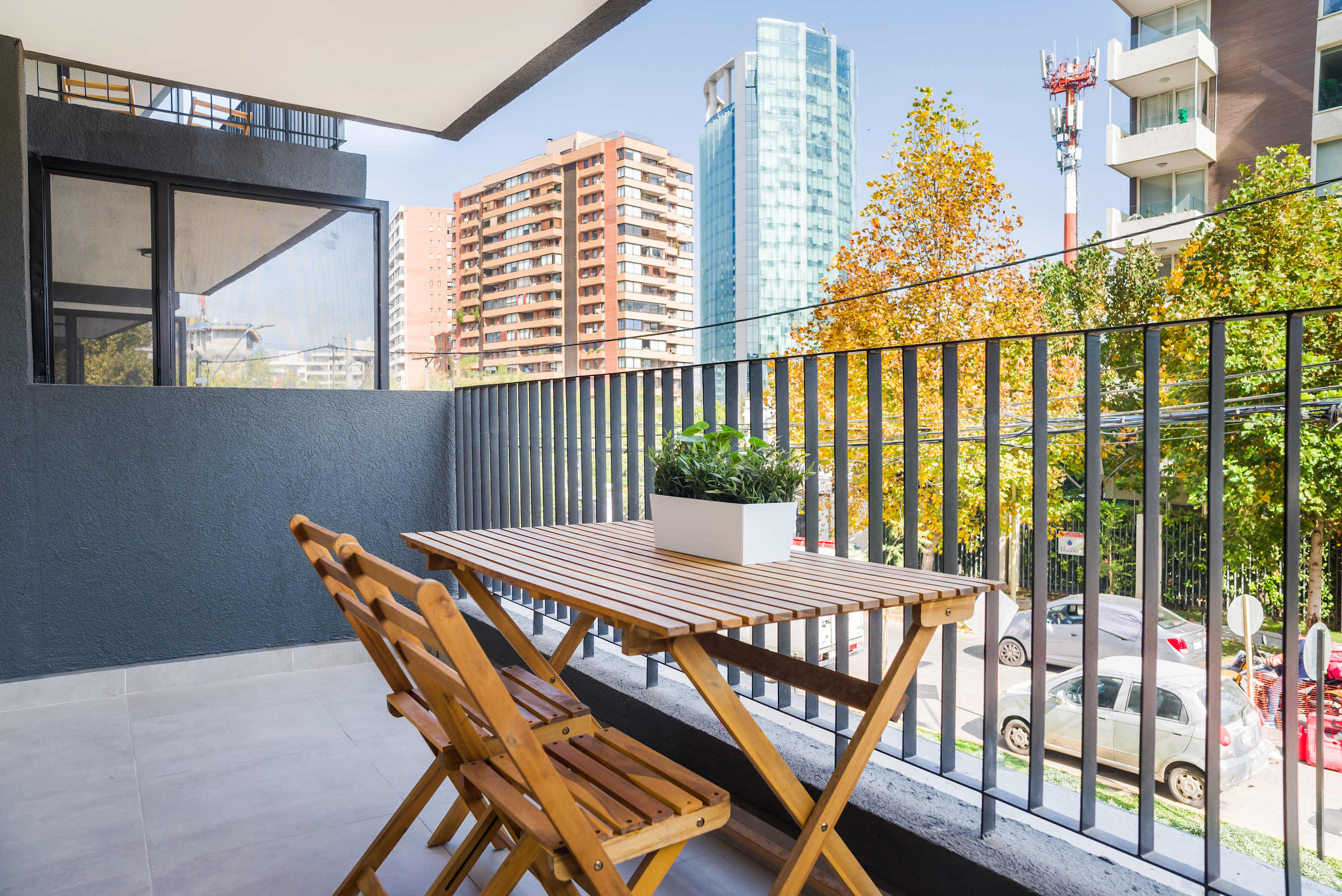 Enjoy your morning coffee on this private balcony with city views and a cozy seating area.