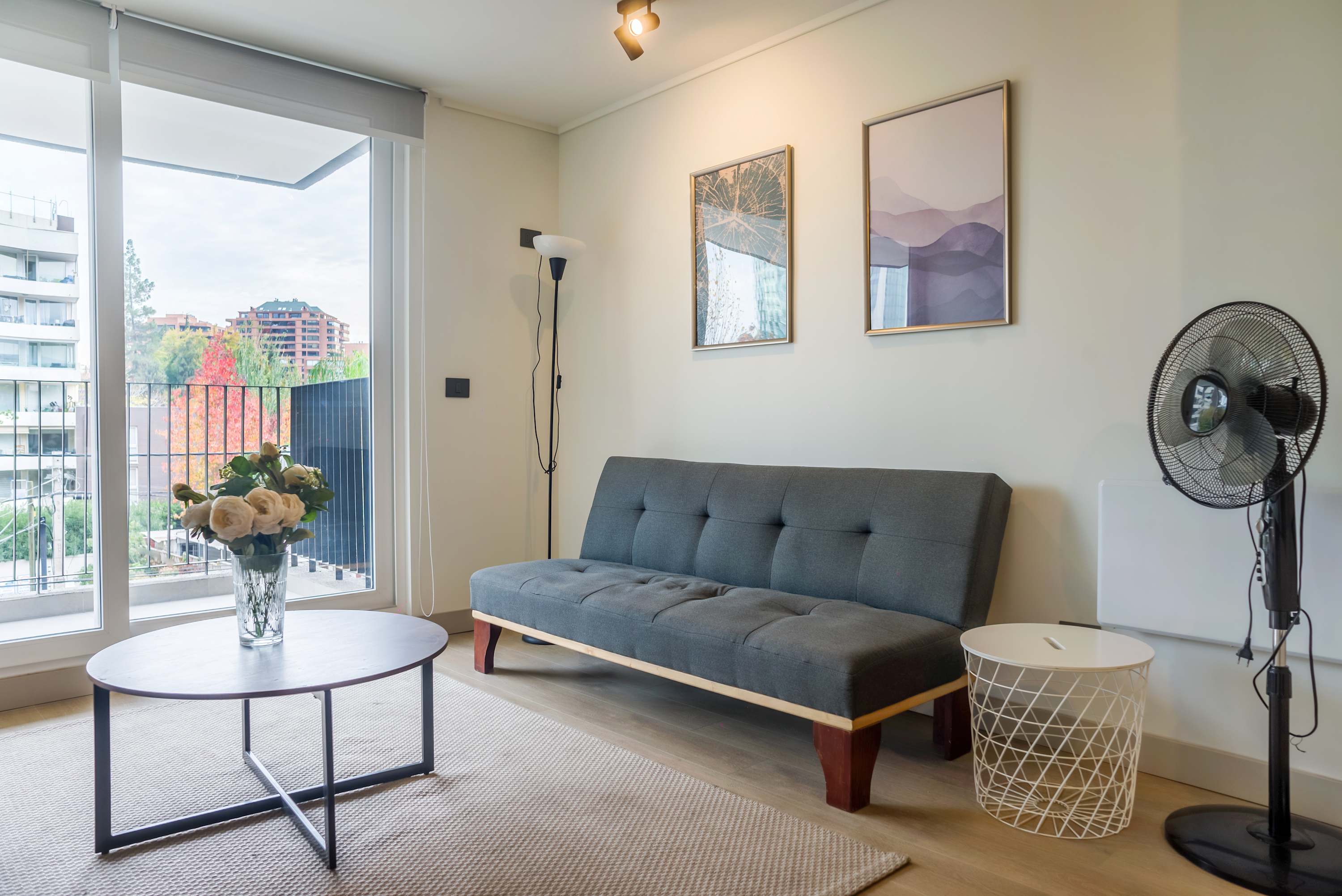 Cozy living area with city views, perfect for relaxation in this modern studio apartment.