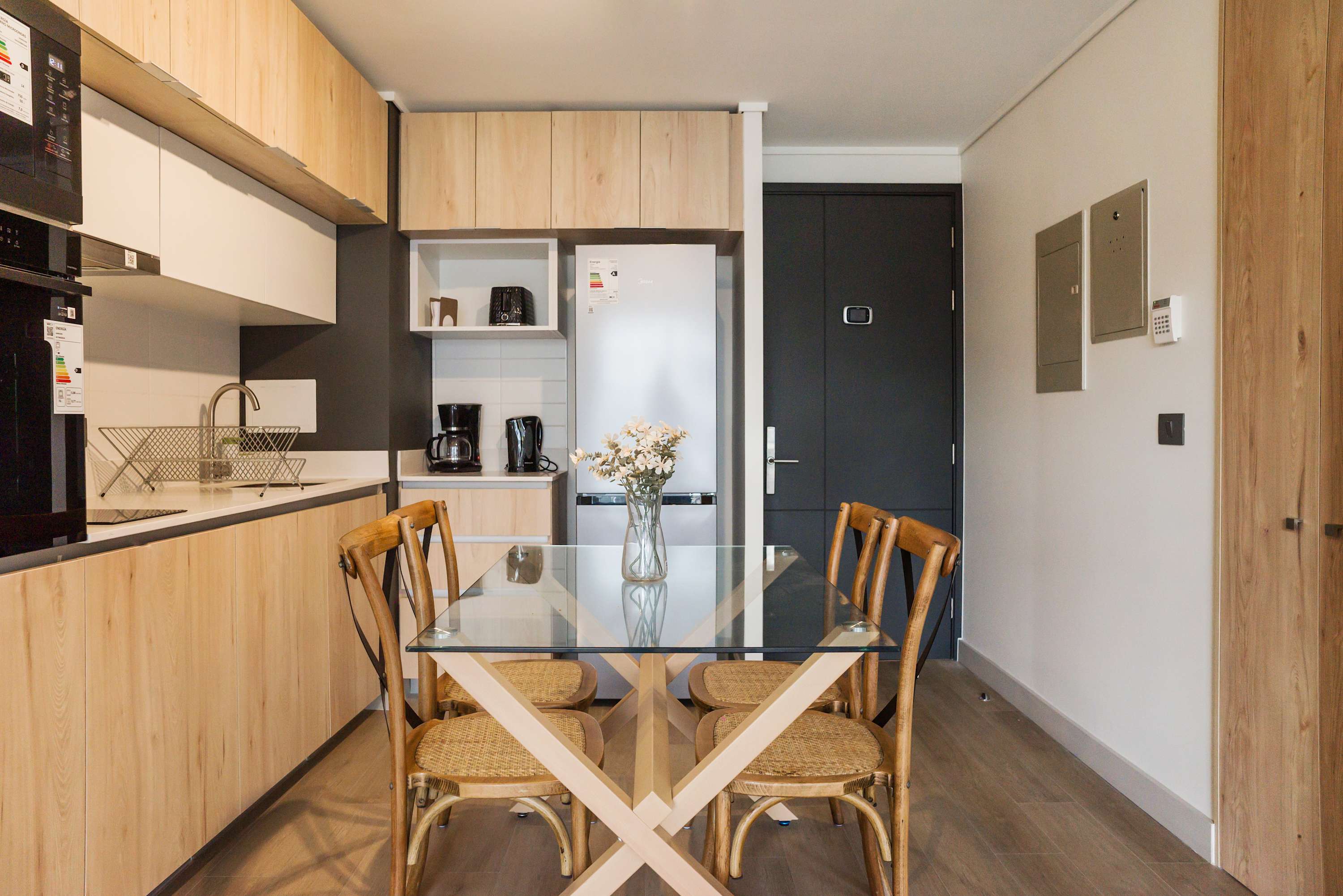 Modern kitchen with sleek appliances and a cozy dining area, perfect for enjoying meals in style.