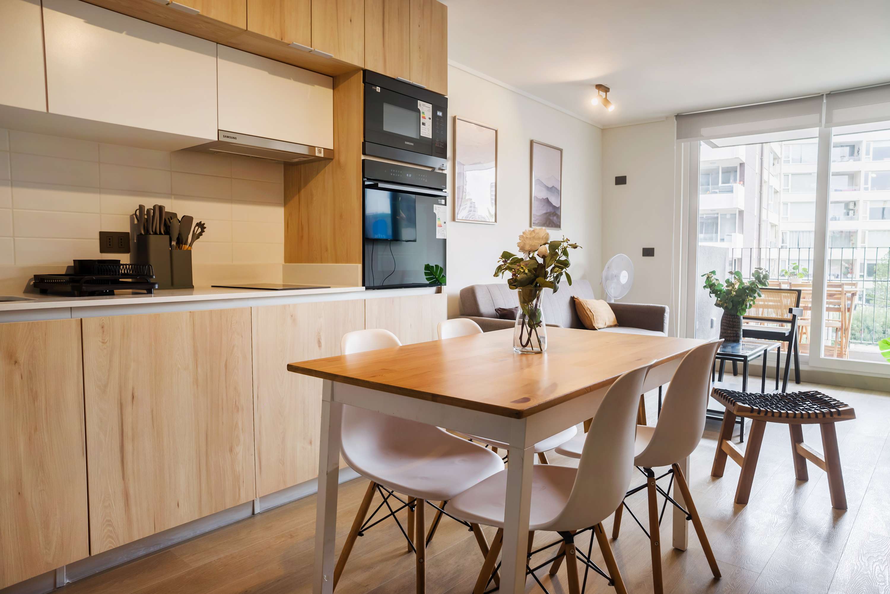 Bright and modern kitchen with dining area, perfect for cozy meals and relaxation with a view.
